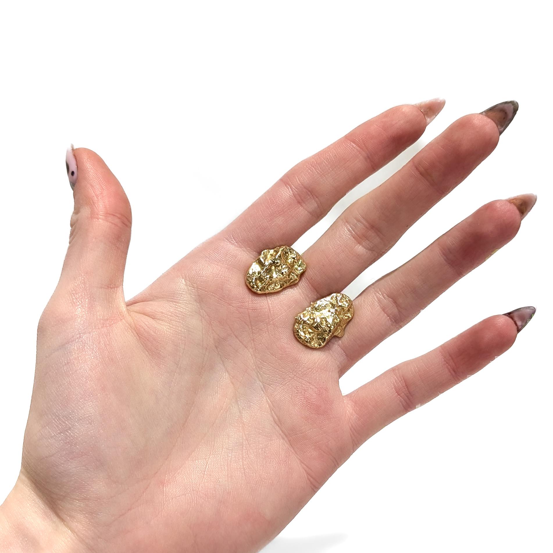A fine pair of gold nugget cufflinks.

In 14 karat yellow gold.

The face and post of each cufflink in the form of stylized gold nuggets.

Marked to the post (illegibly).

Simply a wonderful pair of vintage cufflinks!

Date:
20th Century

Overall