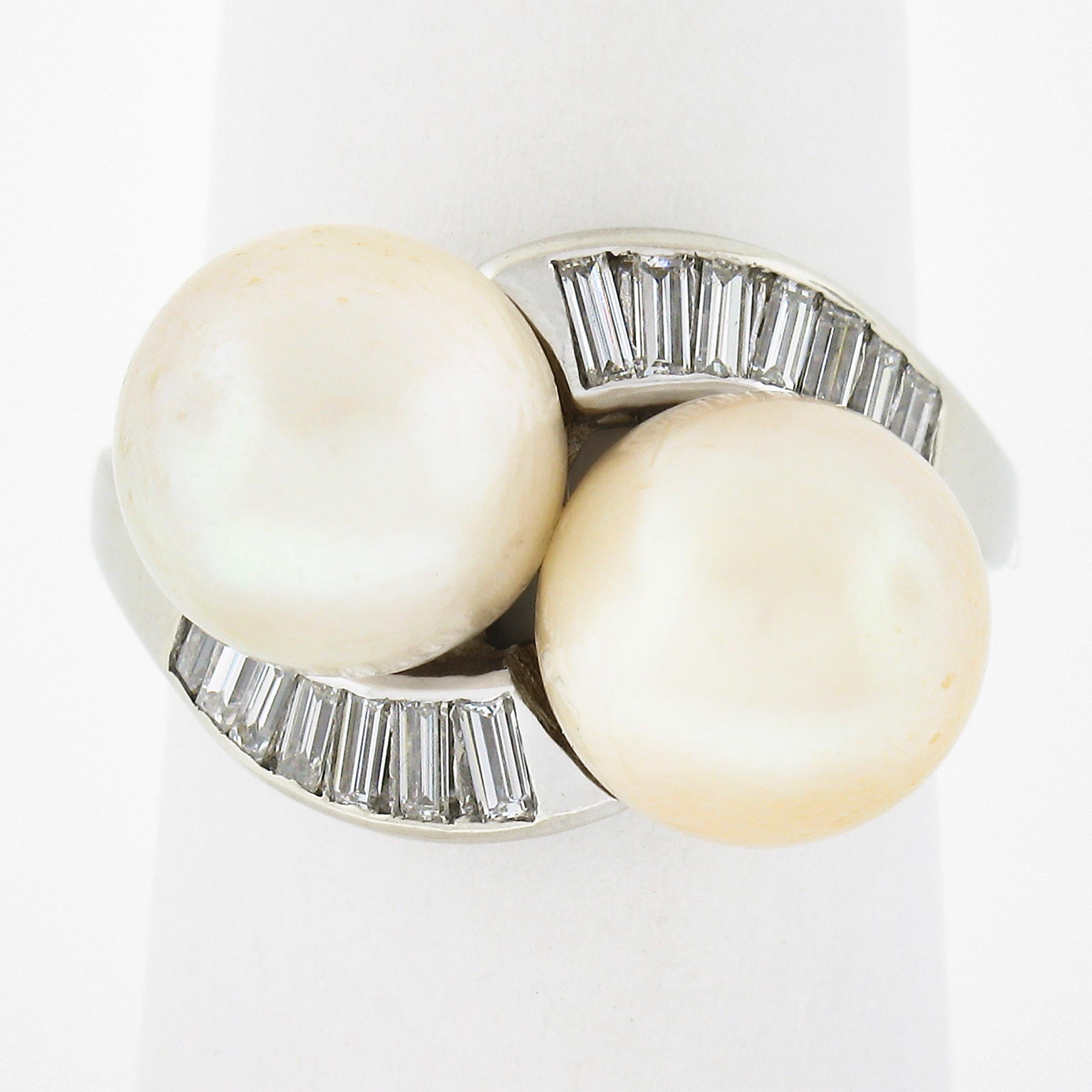 This magnificent vintage cocktail ring is crafted in solid 14k white gold and features an elegant bypass design that carries two, GIA certified button shape cultured saltwater pearls with light cream body color and pink overtone. The bypass design