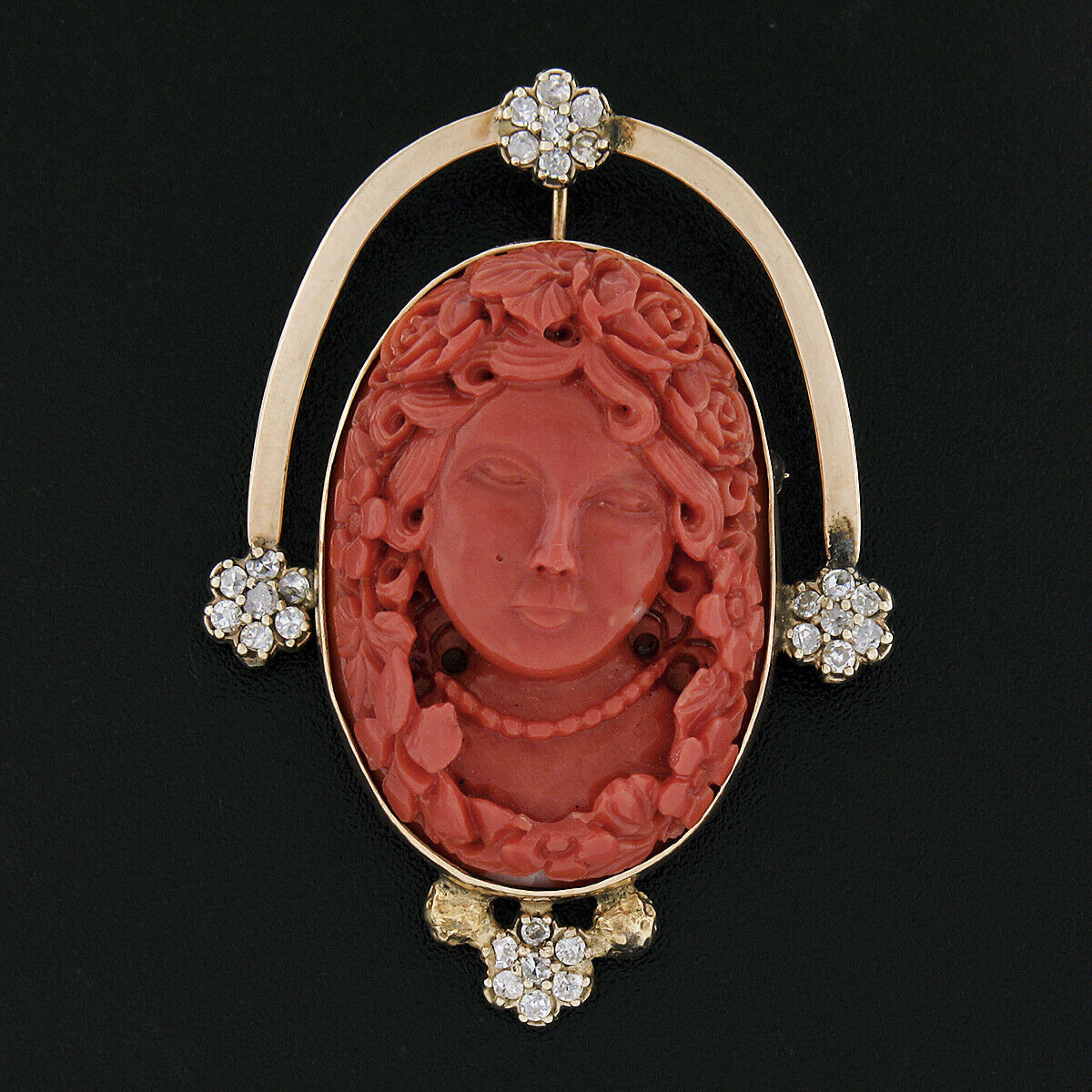 Here we have a magnificent vintage pin/brooch or pendant that was crafted from solid 14k yellow gold featuring a large, GIA certified, natural coral neatly bezel set at the center in which has been masterfully carved showing an incredibly detailed