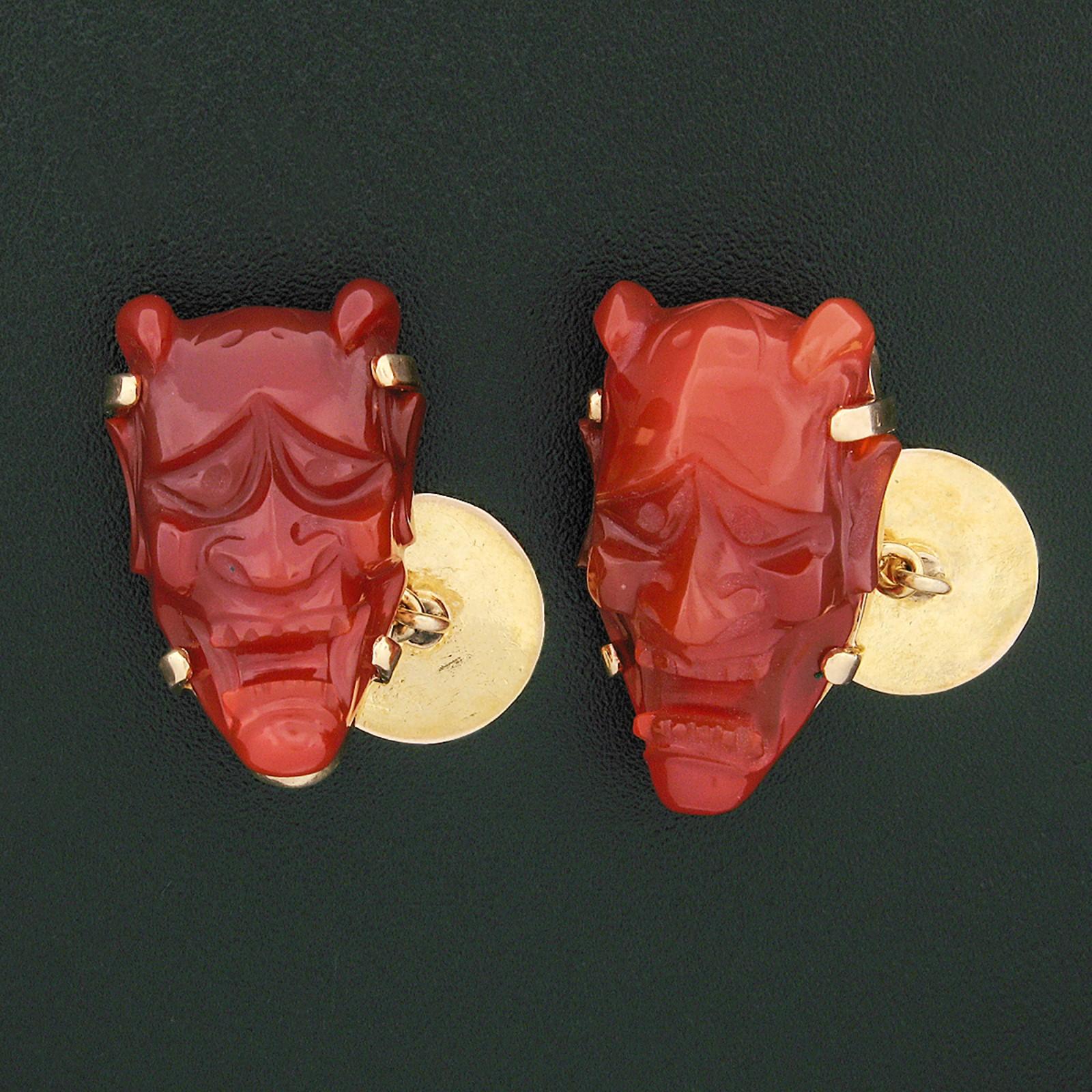 Here we have a vintage pair of hand carved carnelian cuff links crafted from solid 14k yellow gold. Each of the cuff links feature a large piece of carnelian hand carved into the shape of a Japanese-style demon or The Hannya mask. One of the stones