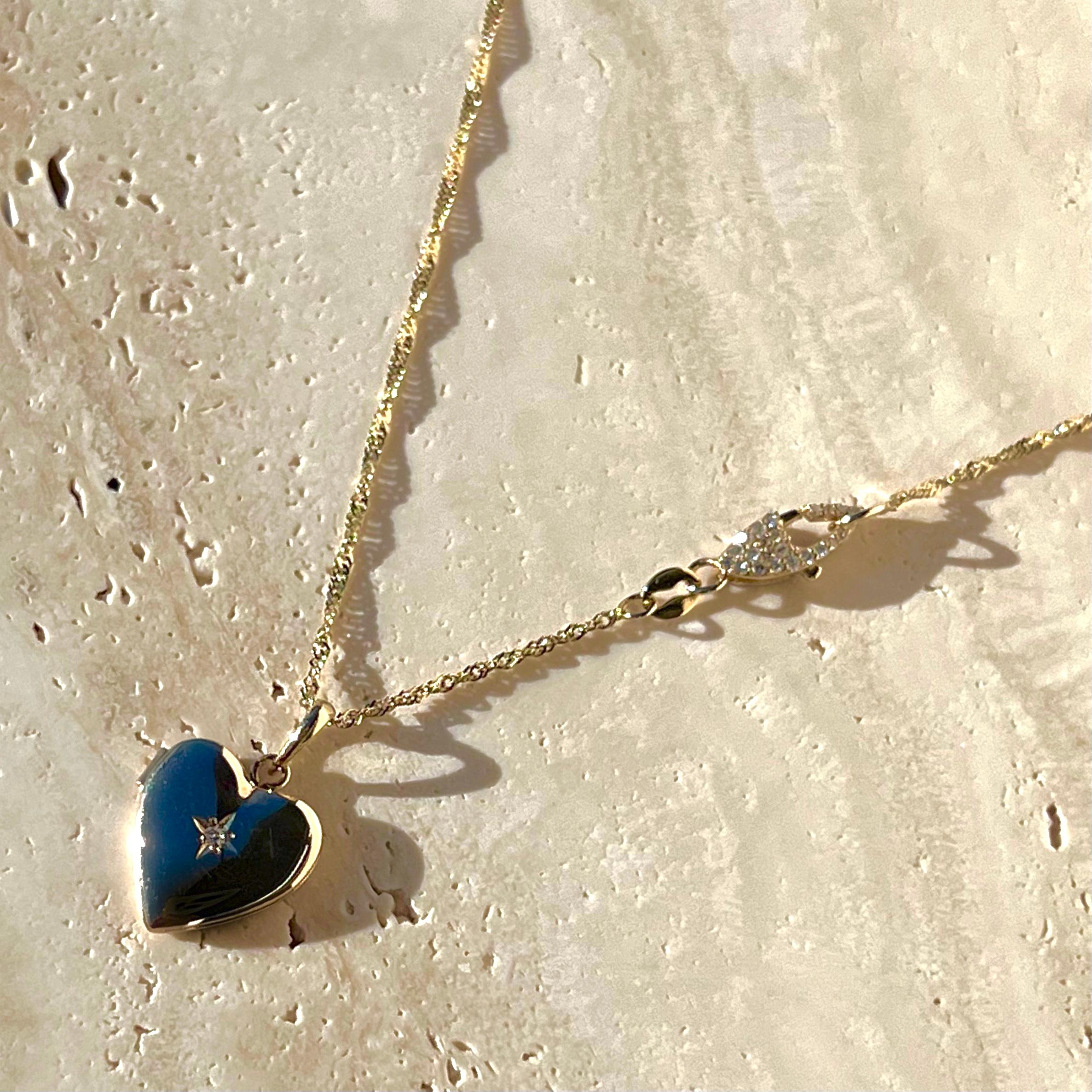 A vintage 14k gold and star set diamond heart locket from the 1960s/1970s. Paired with a custom pavé double-sided diamond clasp and solid 14k gold singapore chain. The pendant is a vintage piece in great condition and the chain is new. Can be styled