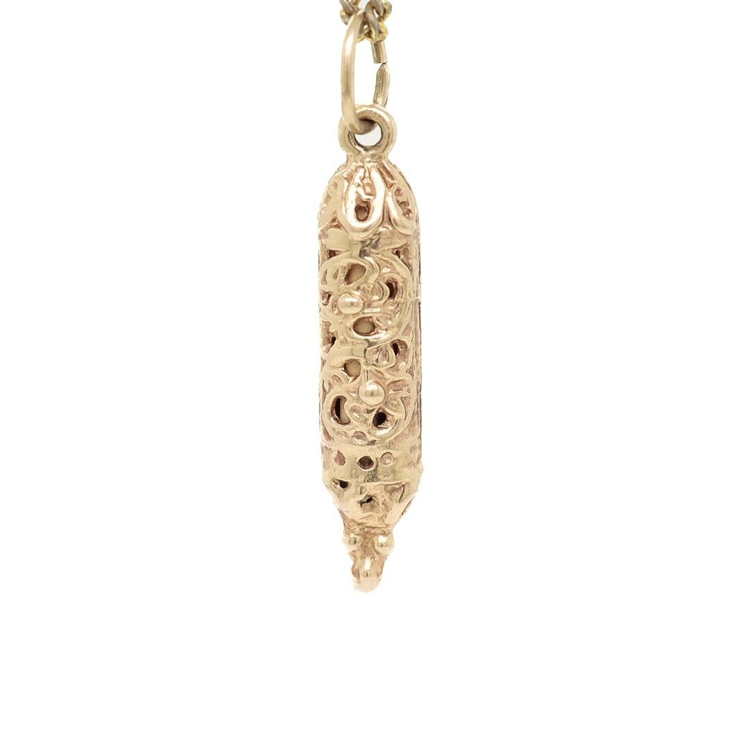 A fine Mezuzah charm for a bracelet.

In 14k gold.

In the form of a miniature Mezuzah.

With an integral bail and jump ring.

Simply a wonderful Judaica charm!

Overall Condition:
It is in overall good, as-pictured, used estate condition. There is