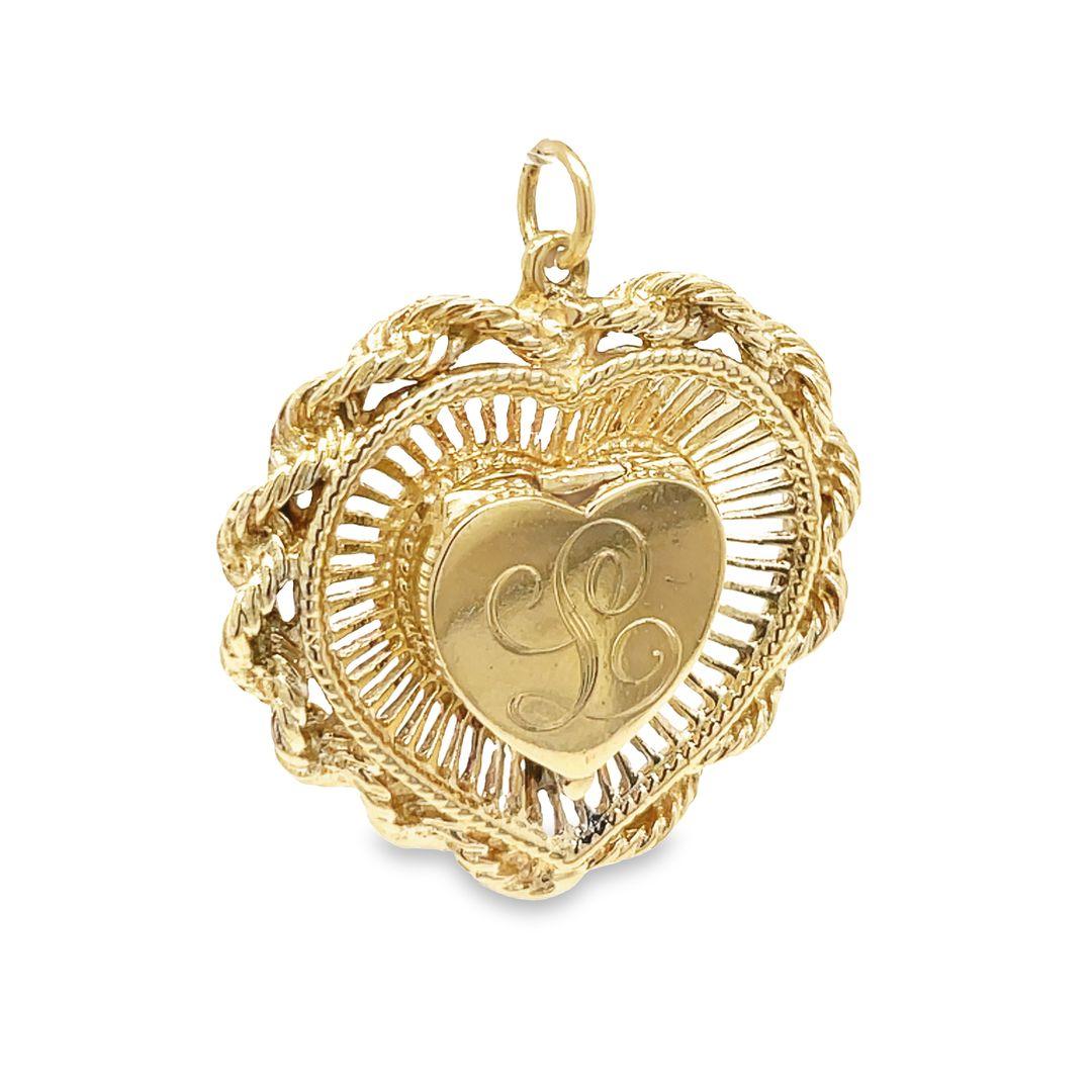 A truly impressive vintage 1950's 14K yellow gold heart locket charm/pendant features a small high polished heart locket at its center, elegantly engraved with the letter 