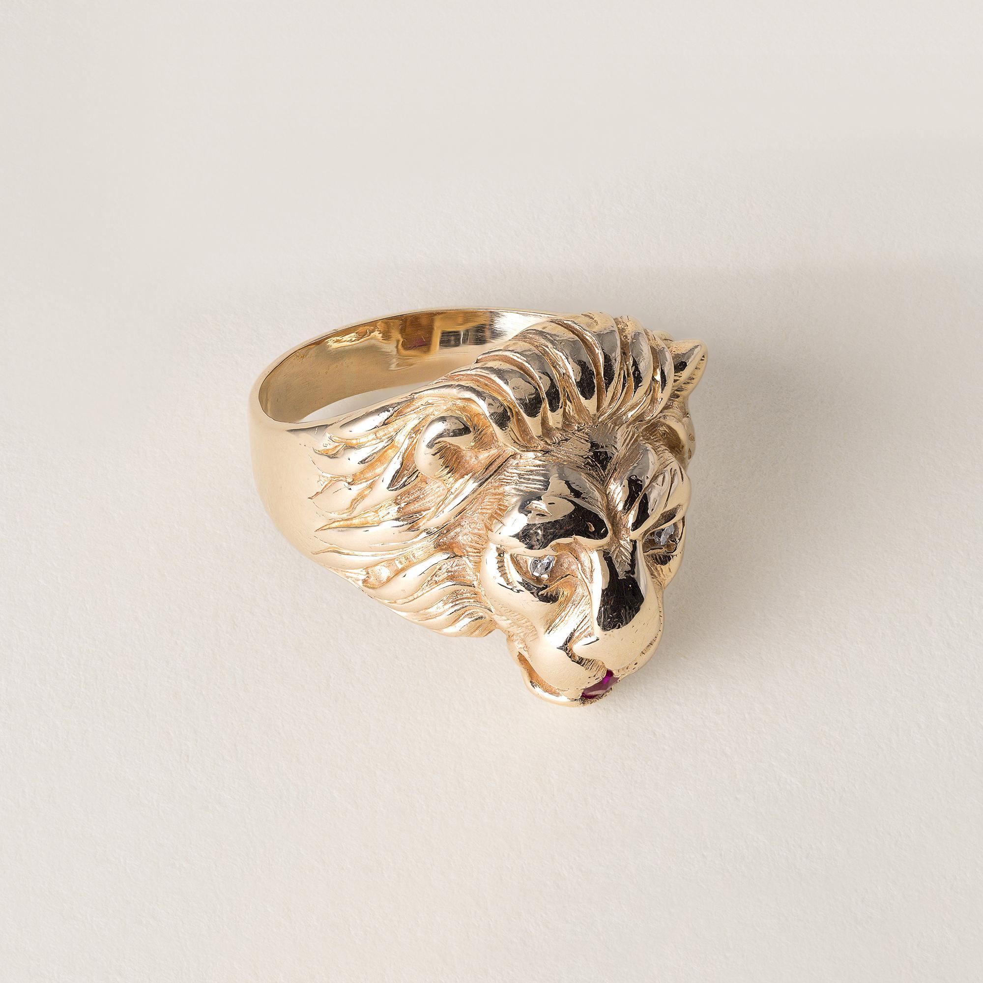 Circa 1980
Lion's head ring featuring a pair of single cut diamonds set in the eyes
and a ruby set in the mouth.
0.04 carats diamonds
E-F VS
0.03 carat round ruby
Ring size 9.75
10.76 grams
Stamped 14K in shank
Band measures 8.5mm tapering down to
