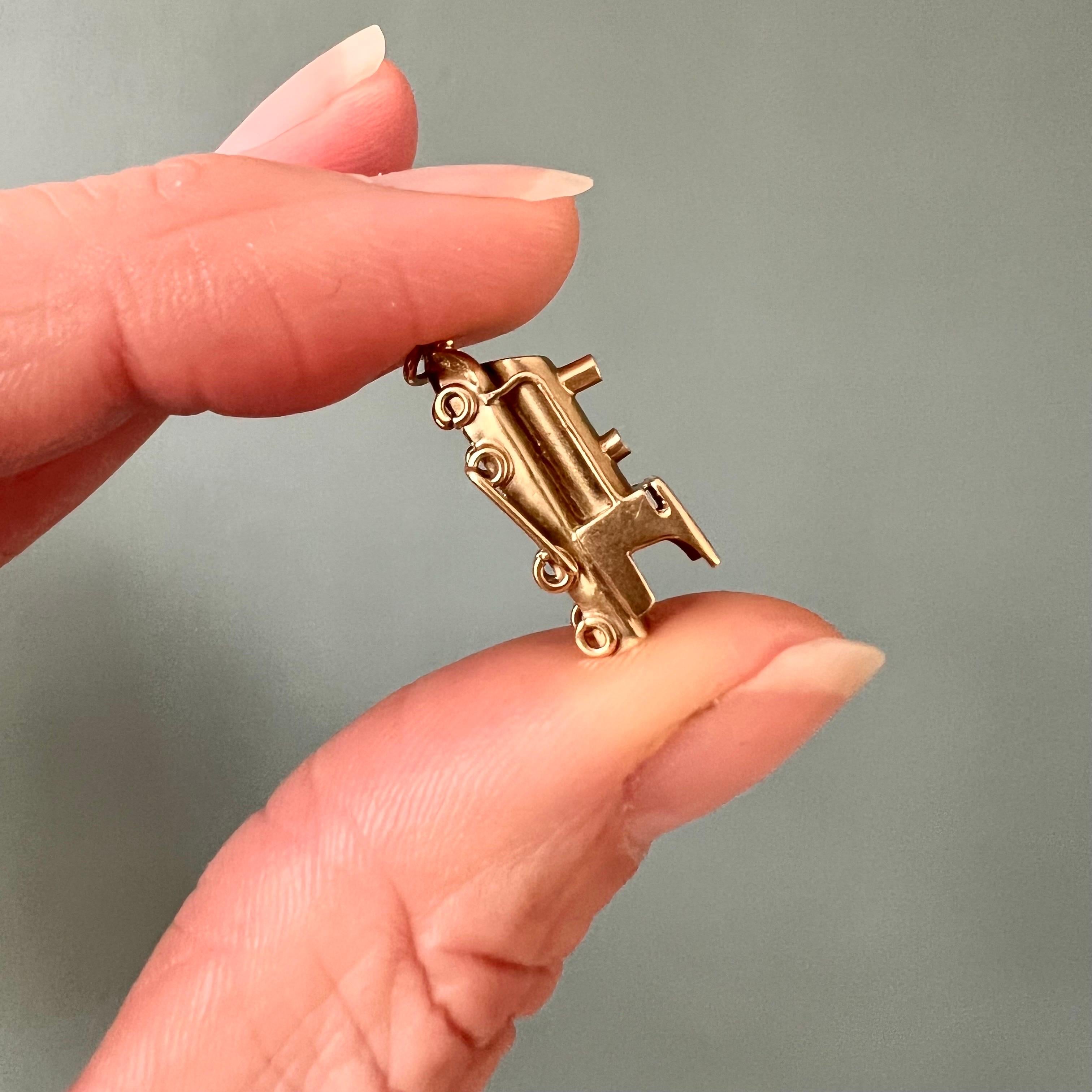 A vintage 14 karat gold locomotive train charm pendant. The locomotive is beautifully detailed with an open cab, a steam dome and sand dome.  

Collect your own charms as wearable memories, it has a symbolic and often a sentimental value. This