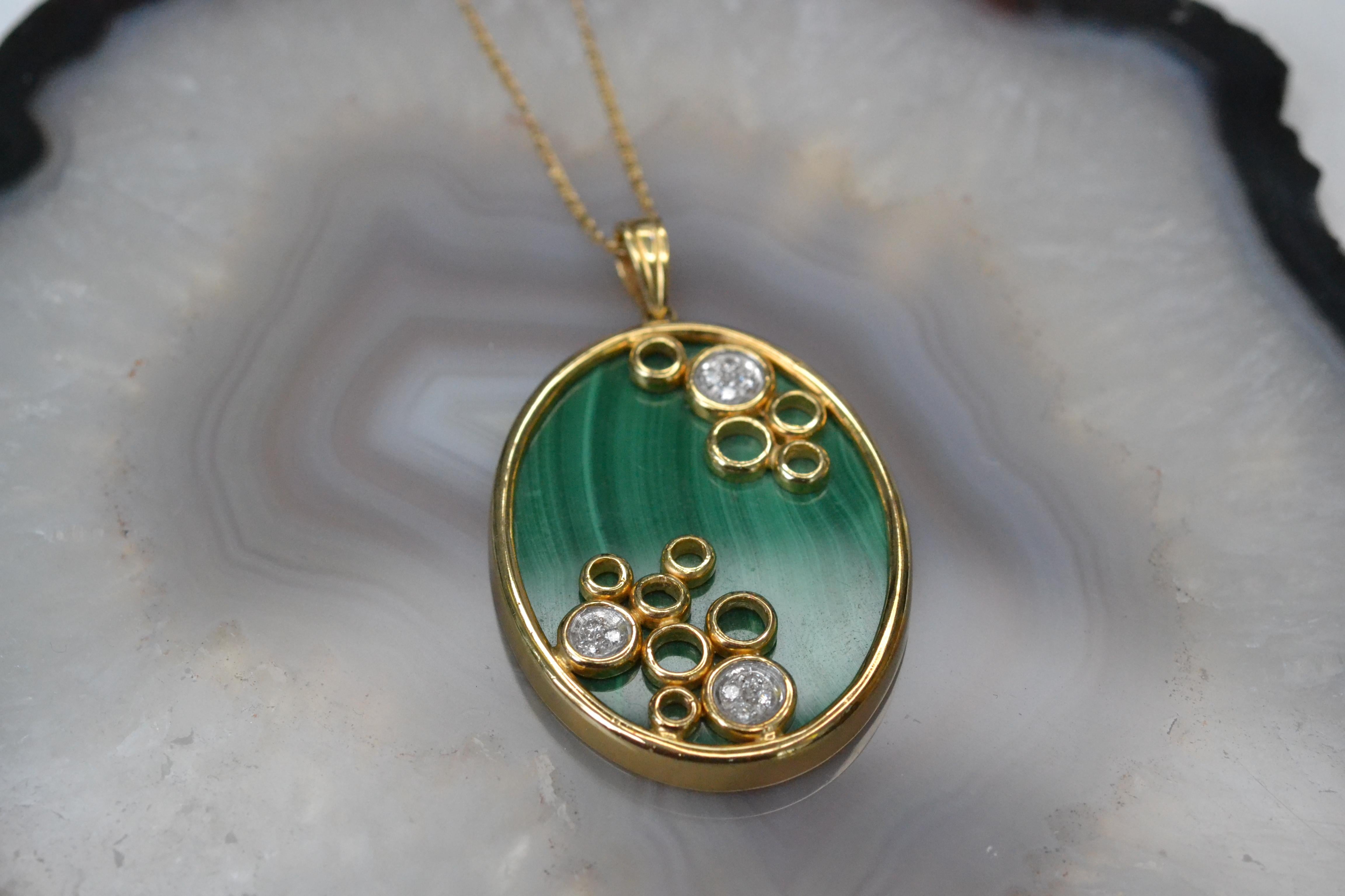 Vintage 14k Gold Malachite and Diamond Pendant

This unique malachite pendant made in the 1980s is the perfect statement necklace: bright, bold and sparkly. The three clusters of white diamonds add an extra dazzle to this eye-catching piece and this