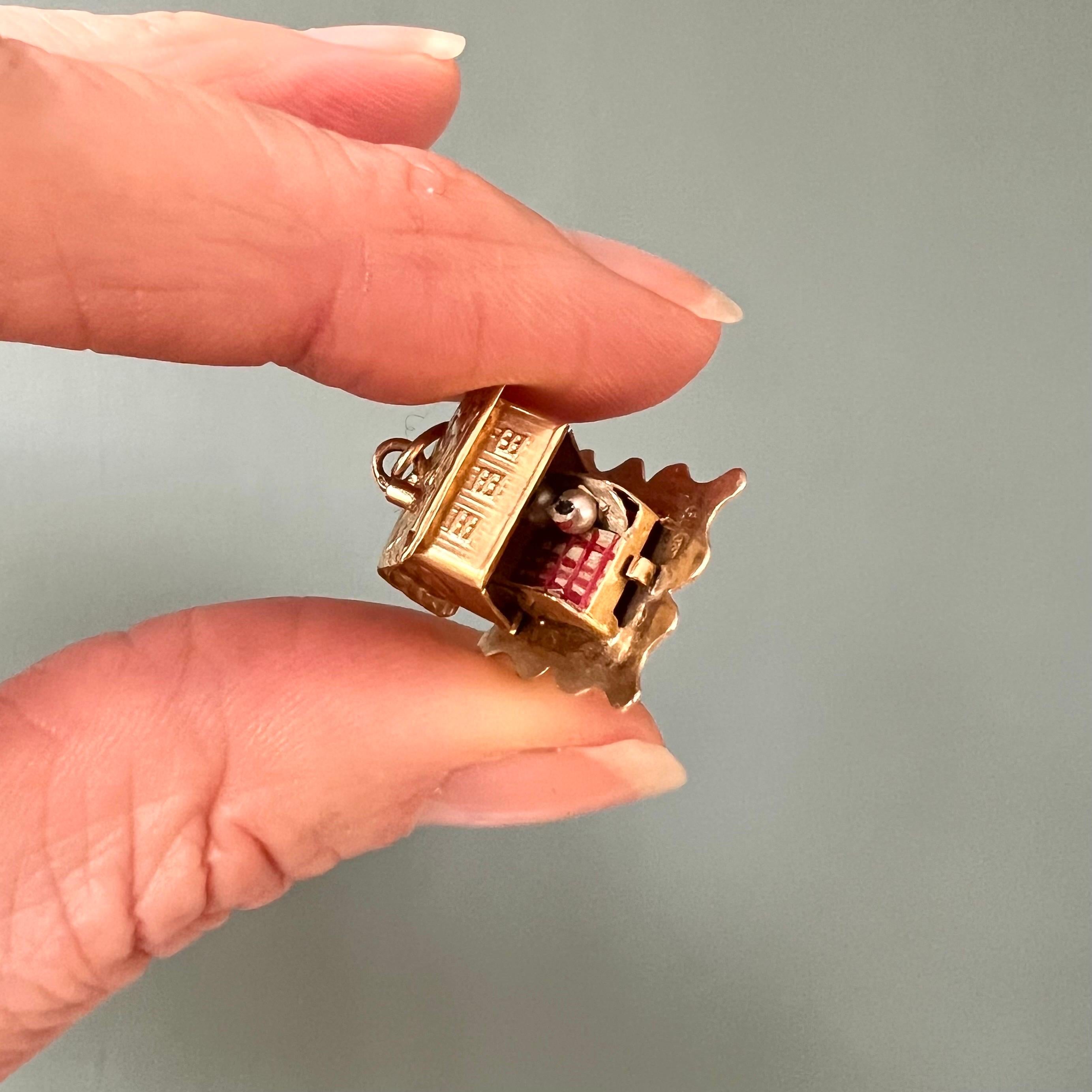 A lovely vintage 14 karat gold cottage cabin charm pendant. The roof of this cabin can be opened, and then a beautiful scene appears of a couple lying in bed nice and warm under a white and red checked blanket. 

Collect your own charms as wearable
