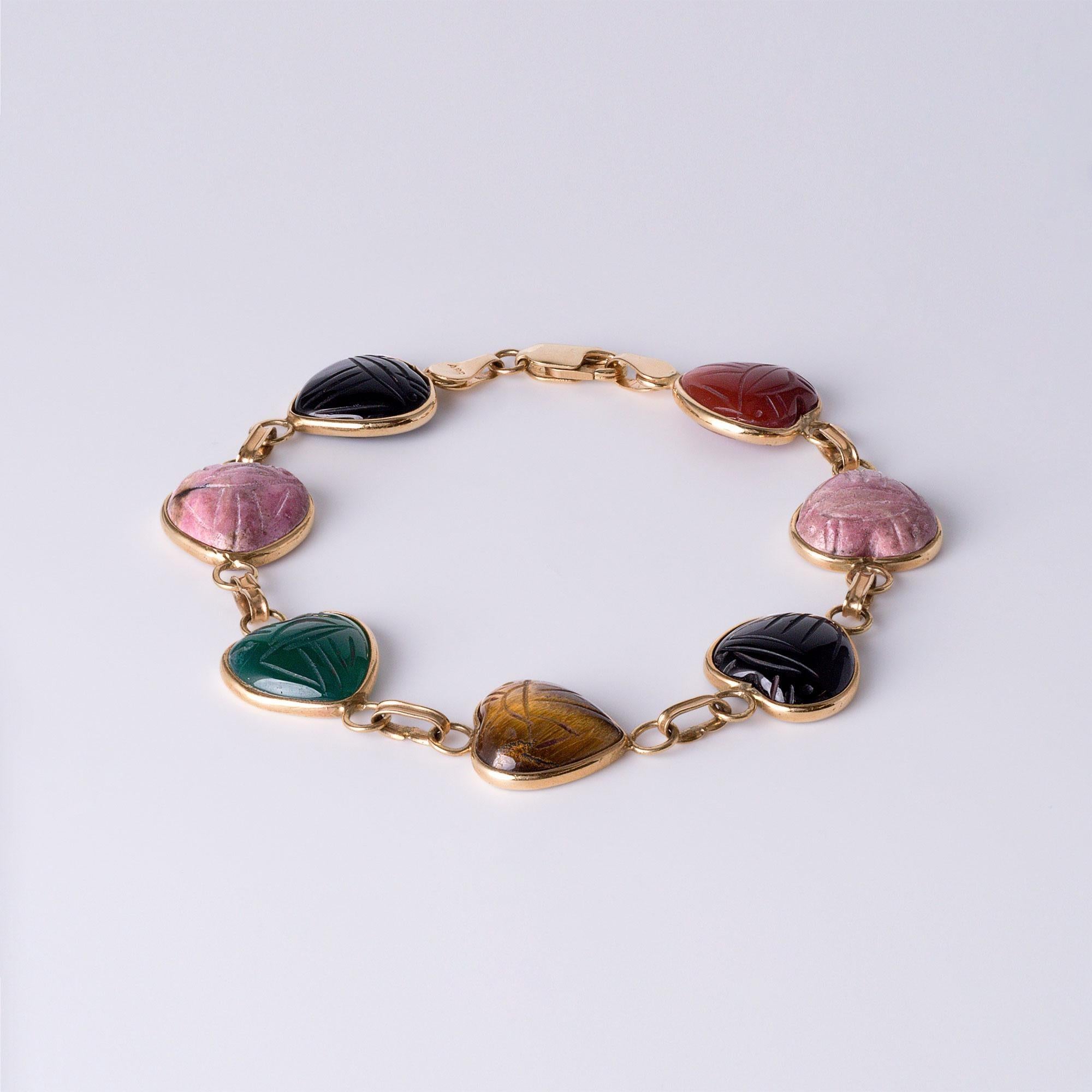 The sweetest heart scarab gemstone bracelet. This charm bracelet Features carved scarab hearts in a beautiful array of gemstones, this piece is both elegant and meaningful.

Gemstones: Onyx, rose quartz, tiger's eye, carnelian, and chrysoprase, each