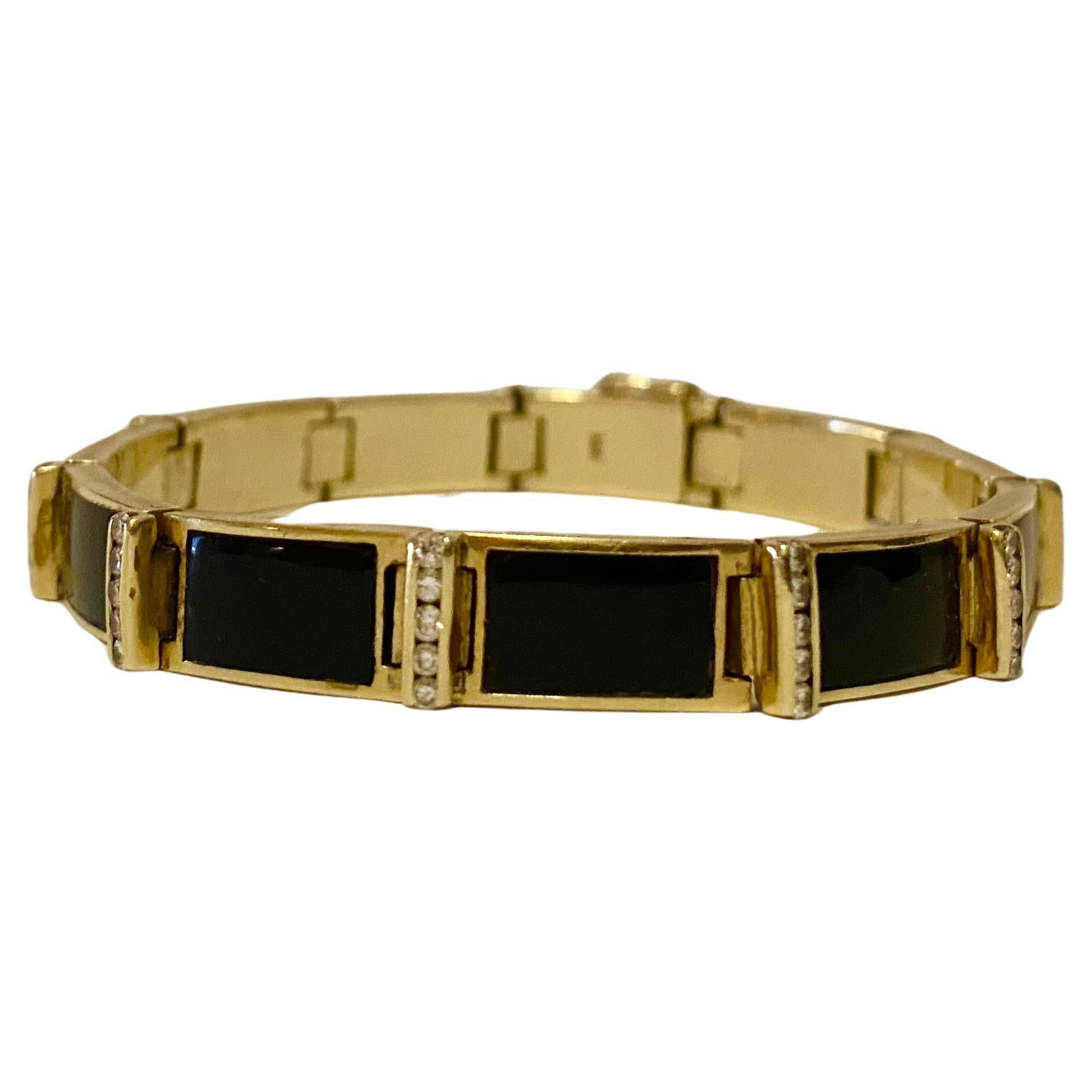 1930s circa, marked 14K (and tested) yellow gold link style bracelet featuring rectangle cut onyx channel set with five round brilliant cut diamonds in between. Hidden box clasp with safety pins. Very good condition. The diamonds are white and clean