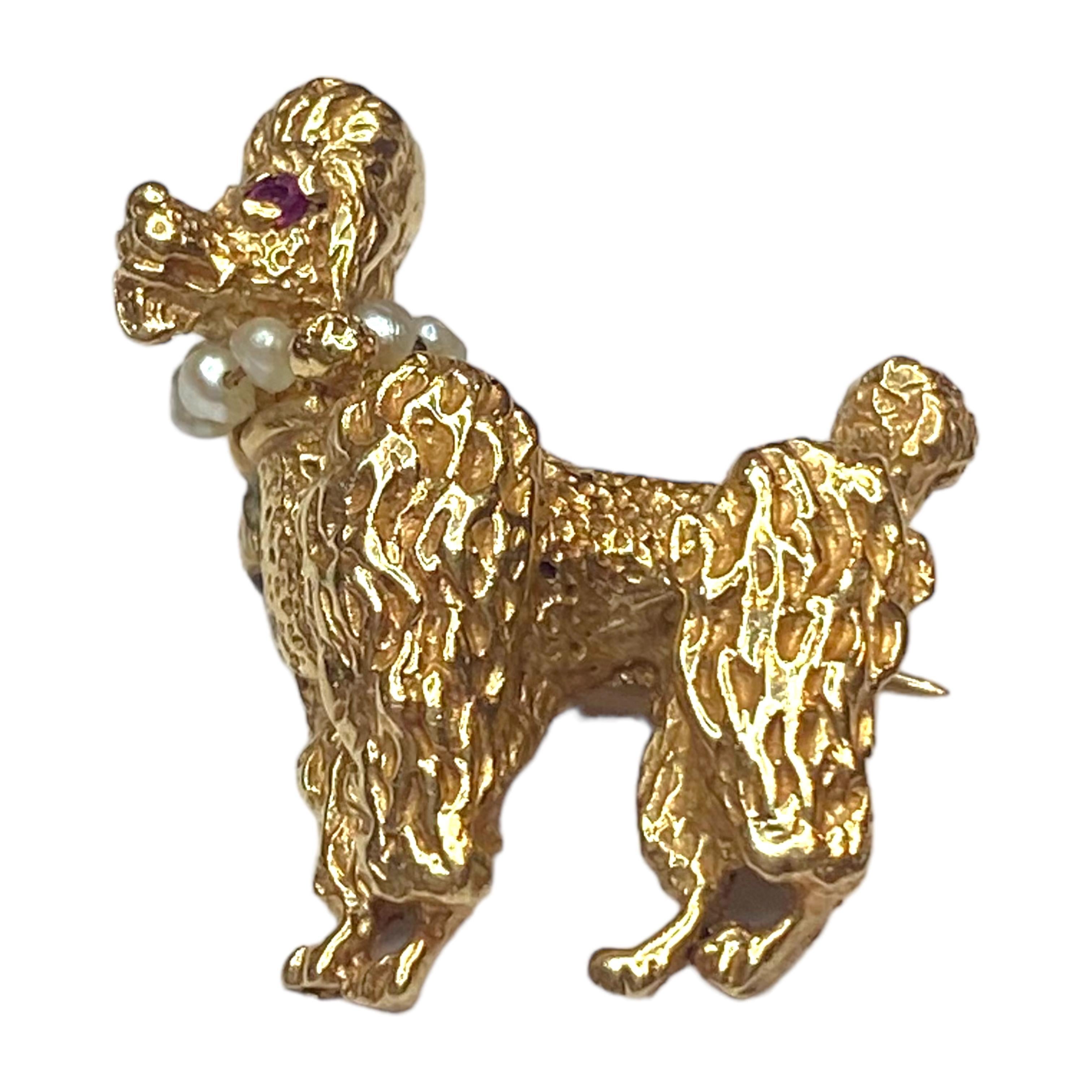 Vintage 14K yellow gold standing poodle with seed pearl collar and ruby eyes.
Measurements: 24 mm H x 22 mm W x 7 mm D (without pin)
Weight: 5.8 grams
Marked: 14K