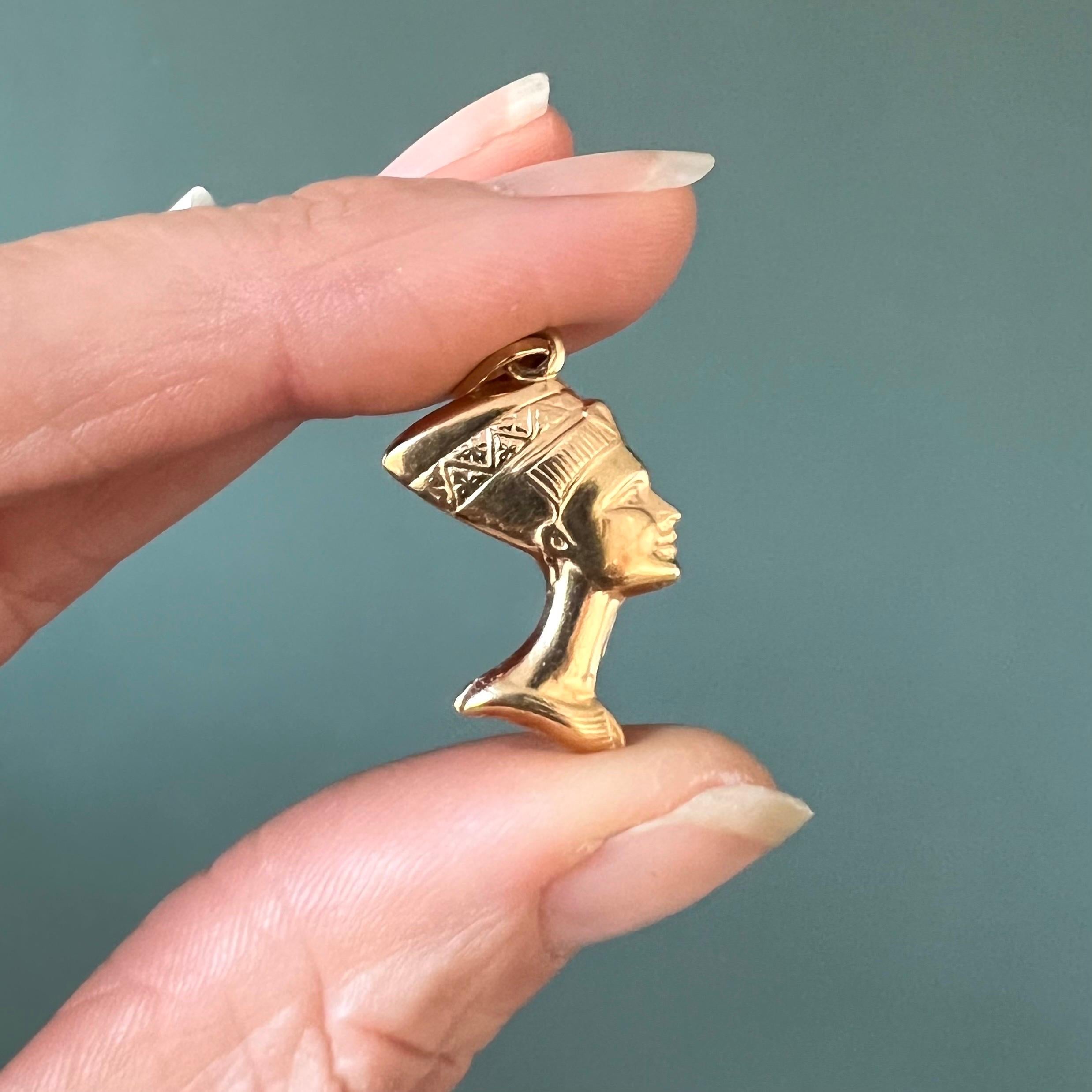 A vintage 14 karat gold Nefertiti bust charm pendant. Nefertiti was - before Cleopatra - one of the most famous and beautiful female rulers of ancient Egypt. This gold queen of the Nile is nicely detailed with her most recognizable bust of her