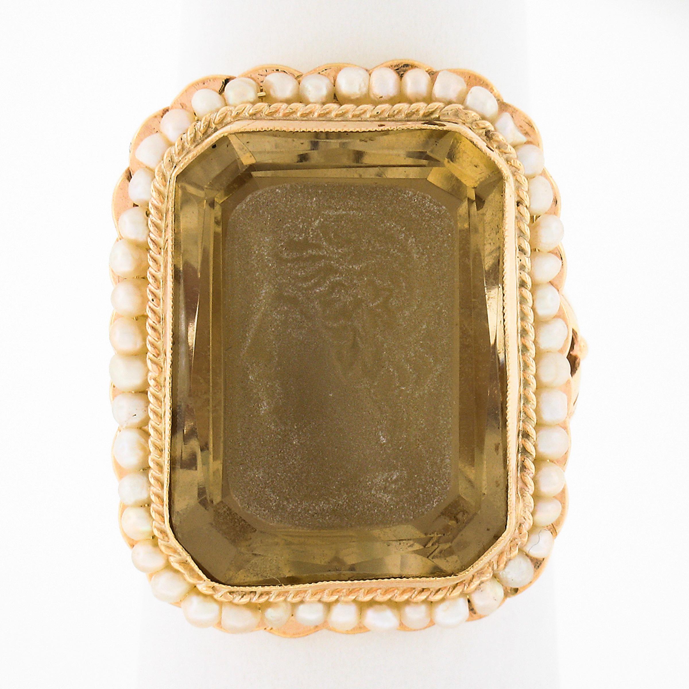This magnificent vintage ring is crafted in solid 14k yellow gold and features a large rectangular shaped citrine solitaire stone which is neatly milgrain bezel set at the center of a twisted wire gold frame. The fine stone displays a warm light