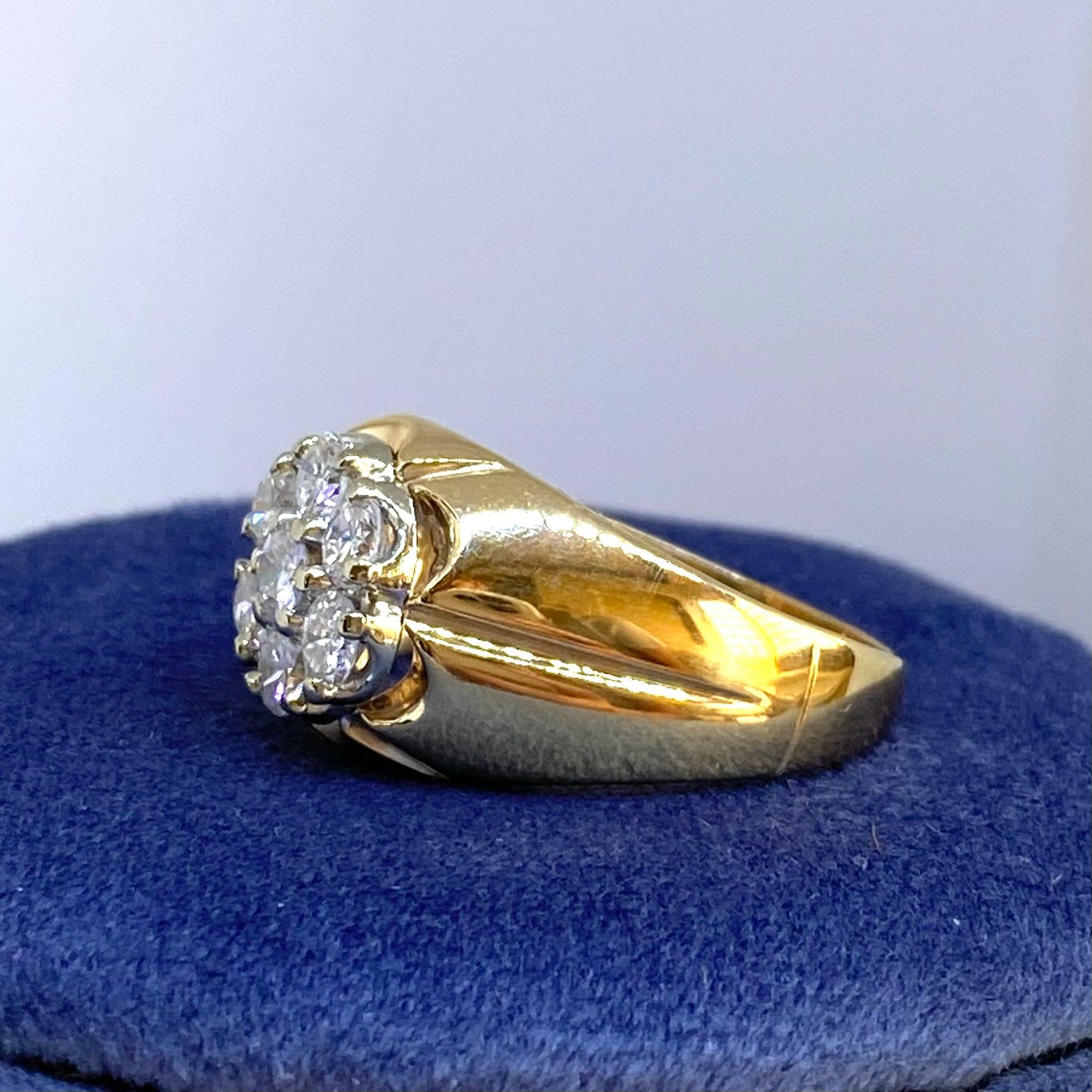 Crafted in 14K gold, the ring features a seven stone diamond floret cluster set in white gold set within a scalloped yellow gold bezel, supported by beveled shoulders and a 2.5mm wide band.
7 round brilliant cut diamonds: 1.00cttw. Color: G-H,