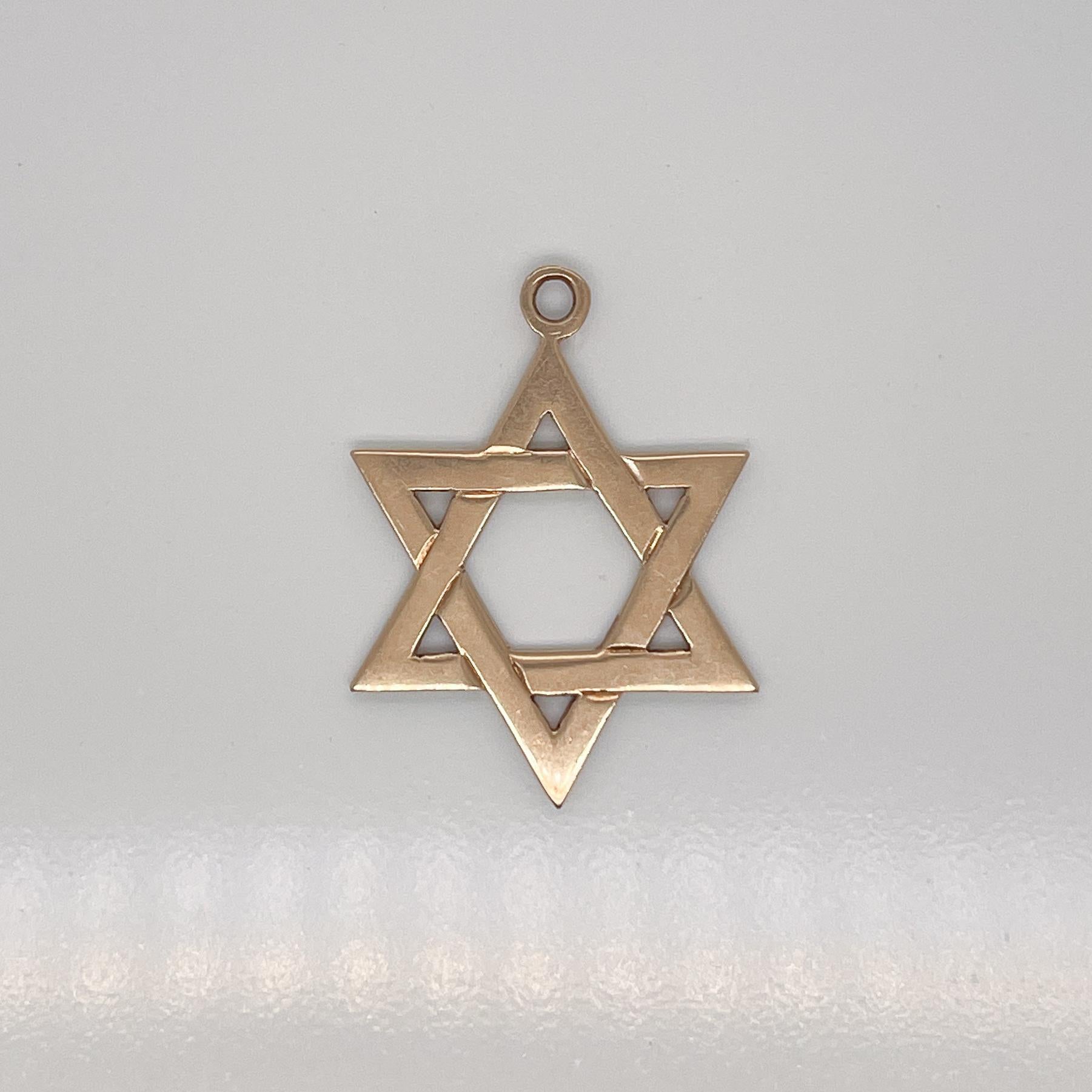A vintage 14 karat gold charm for a charm bracelet. 

In the form of the Star of David.

A rare and terrific charm!

Date:
Mid-20th Century

Overall Condition:
It is in overall good, as-pictured, used estate condition with some very fine & light