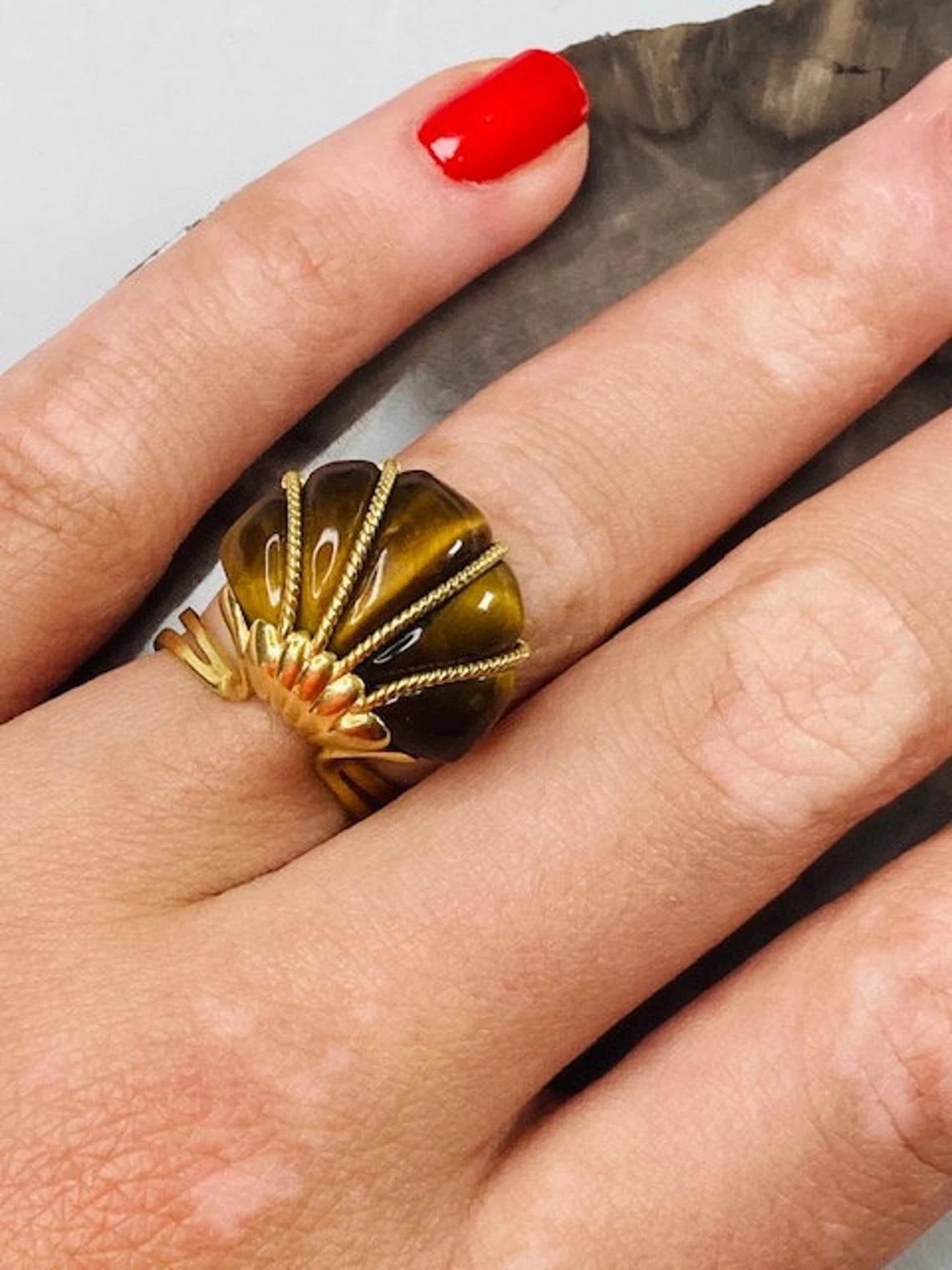 Vintage 14k Gold Tiger's Eye Ring One-of-a-kind

This vintage cushioned tiger's eye ring with 14k gold details and band is a striking yet wearable piece, perfect for any occasion. Made in the 1980s, this ring comfortably fits a size M