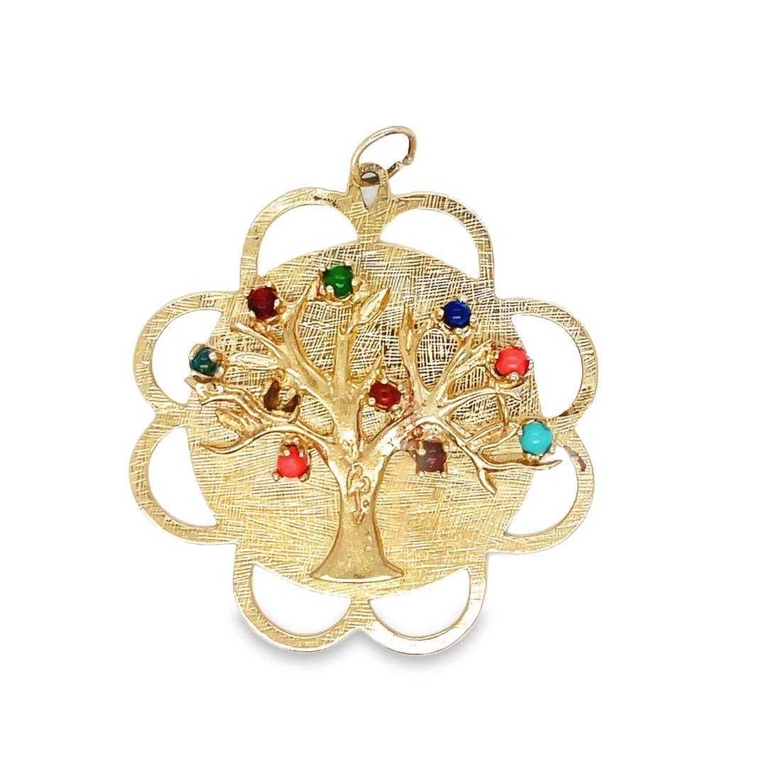 Bold and dramatic vintage 14K gold charm/pendant featuring  a tree of life set with multicolor gemstones in center.

The round center disc is beautifully encircled by a scalloped edge design. Textured background adding a touch of sophistication and