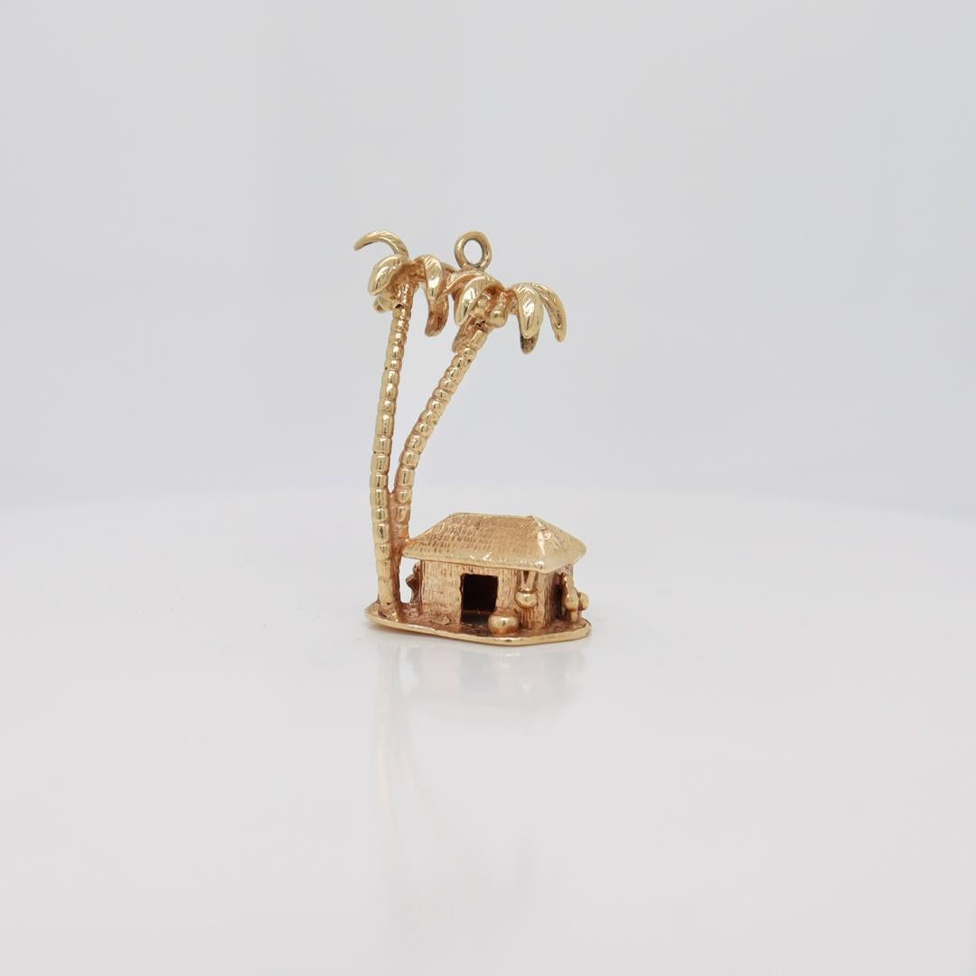 A fine figural charm for a bracelet.

In 14k gold.

In the form of a miniature tropical beach hut with 2 large palm trees.

With an integral bail to the top.

Simply a wonderful gold charm!

Date:
20th Century

Overall Condition:
It is in overall