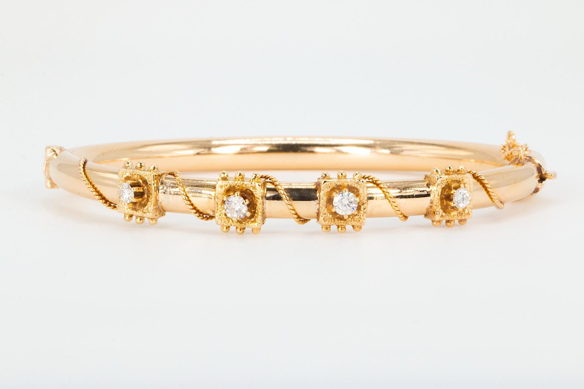 Vintage 14K Gold Twisted Rope & .40 CTW Diamond Hinged Bangle Bracelet

A classic vintage design, this 14K yellow gold hinged bangle bracelet features a twisted rope accented with four round brilliant cut natural diamonds. The diamonds are securely