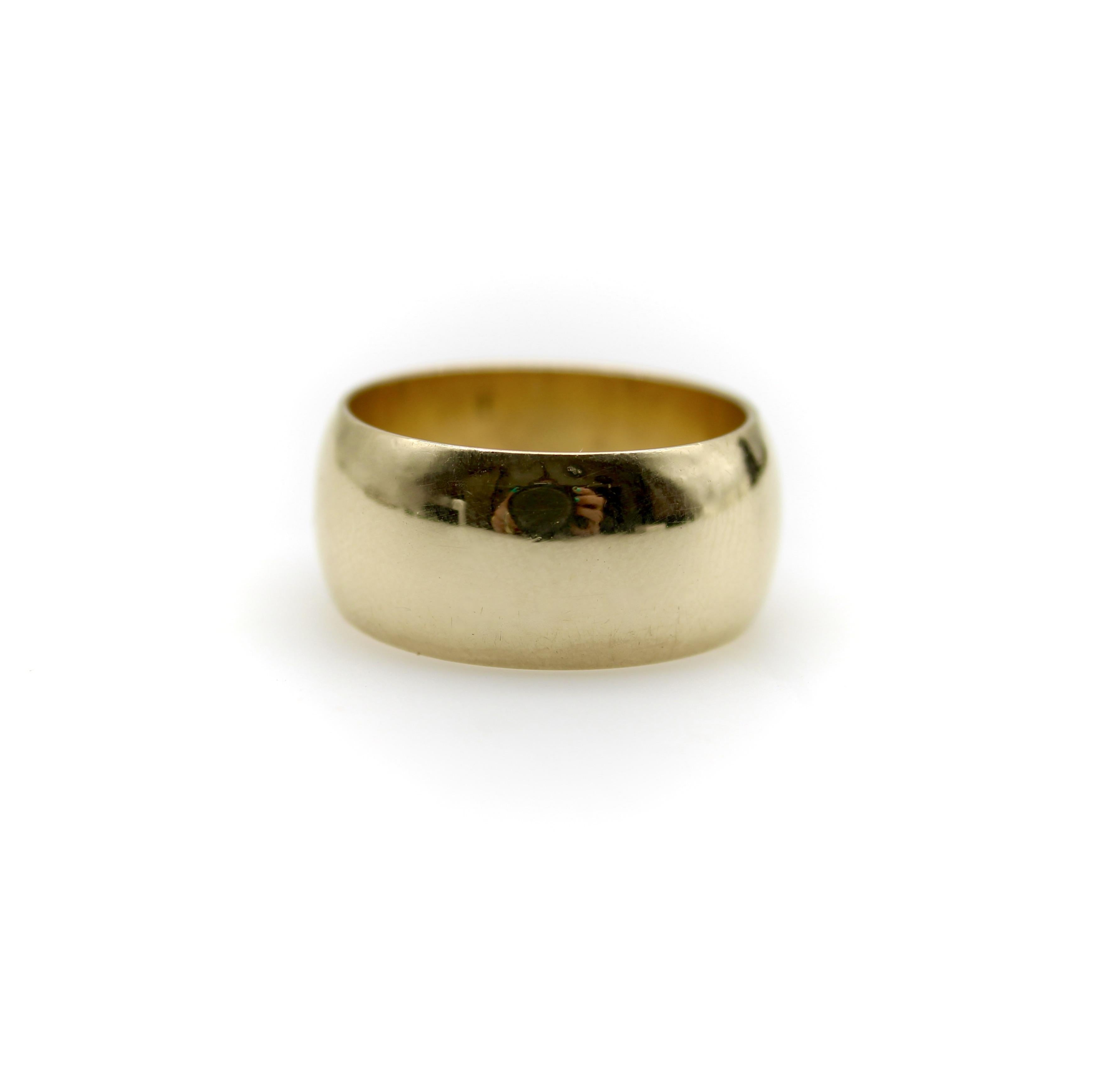 Circa the 1960’s, this classic wide band ring is rendered in 14k gold. It has a gentle convex surface—when looked at in profile, you can see a slight doming to the band. The ring has a great weight to it, giving it presence, and its surface has a