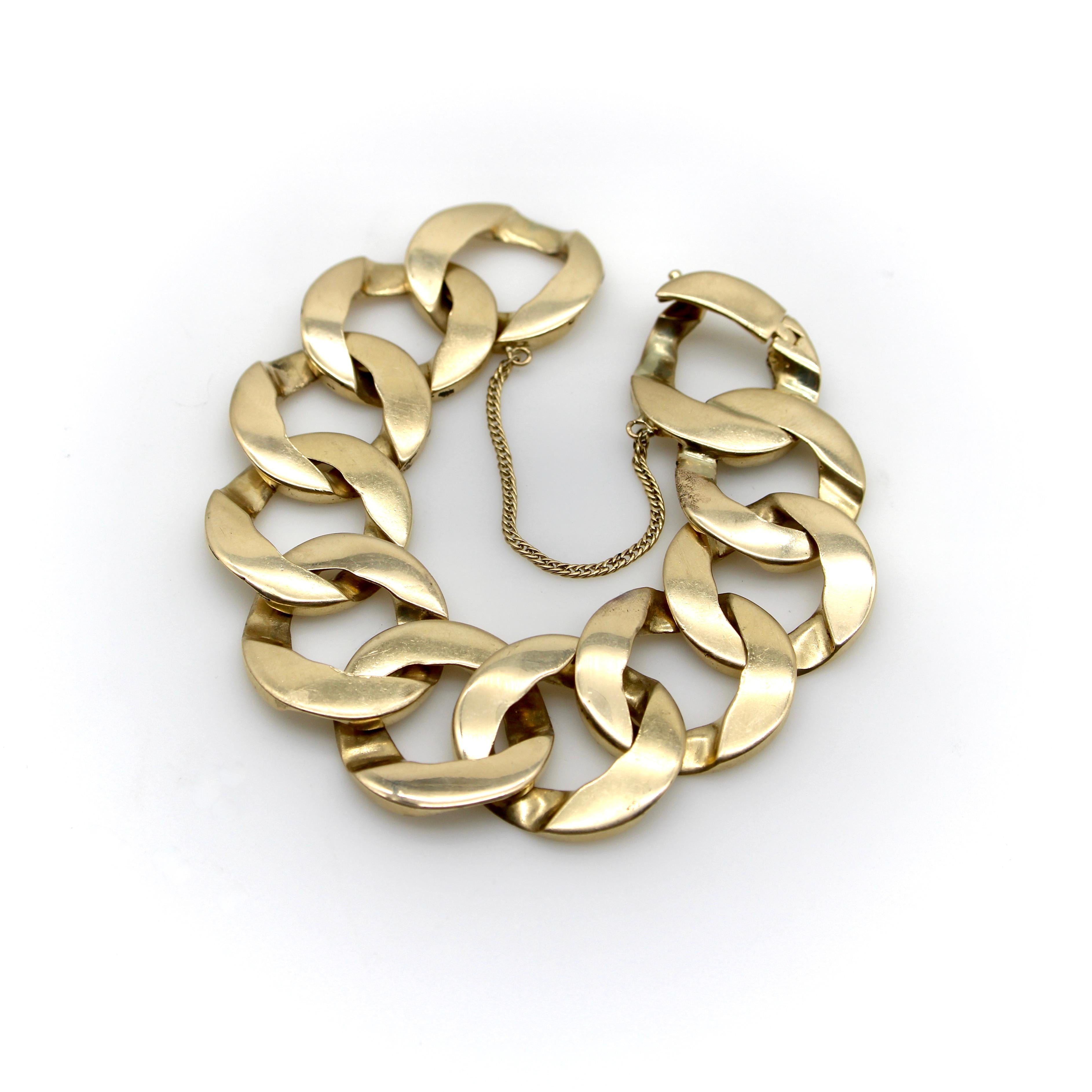 This is an iconic wide flattened curb link bracelet in 14k gold. The design was made famous by Greta Garbo in 1941 when she was rarely seen without one on each wrist. Now this curb link is a truly sought after piece! The beautiful flattened wide