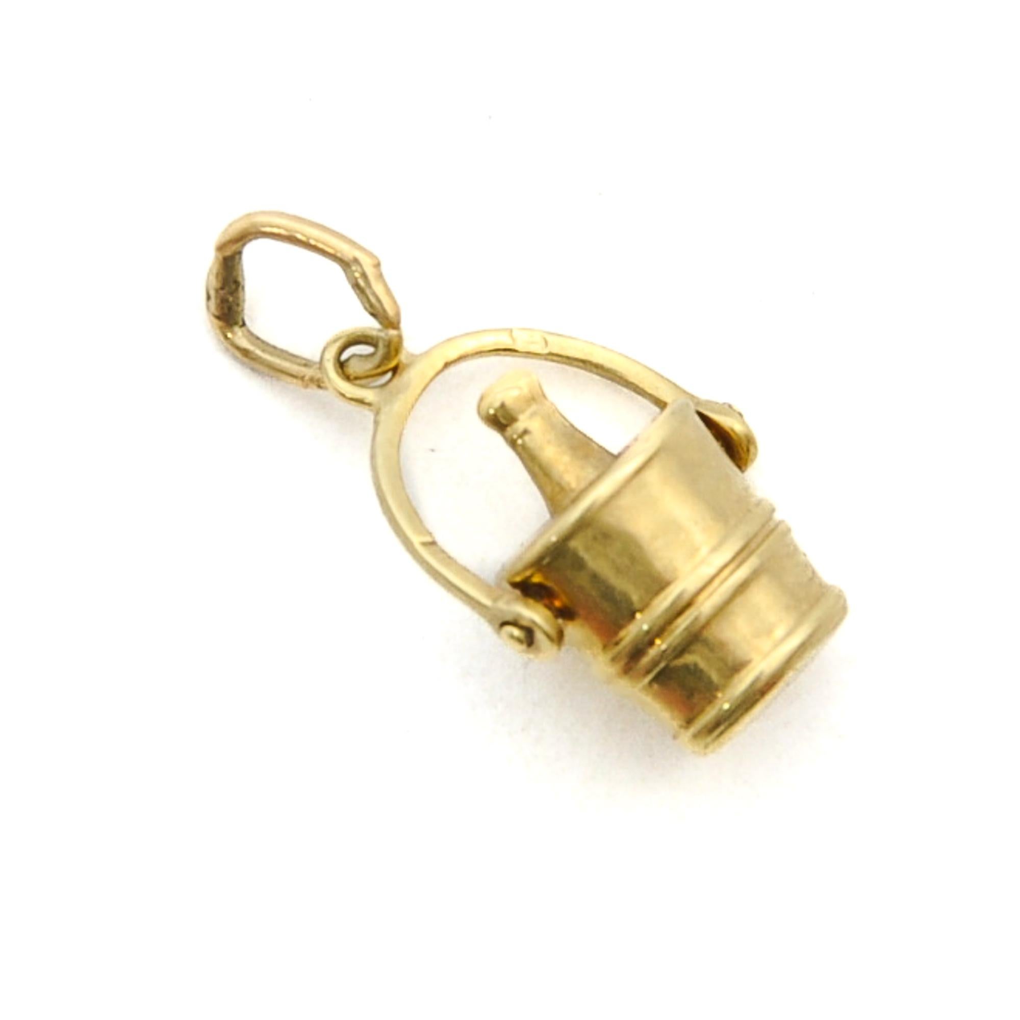 A vintage mid-century gold wine cooler bucket charm pendant. The charm has nice detailing with a movable handle and the bottle is kept cool in this ice bucket. The charm is created in 14 karat yellow gold. Charms are great to collect as wearable