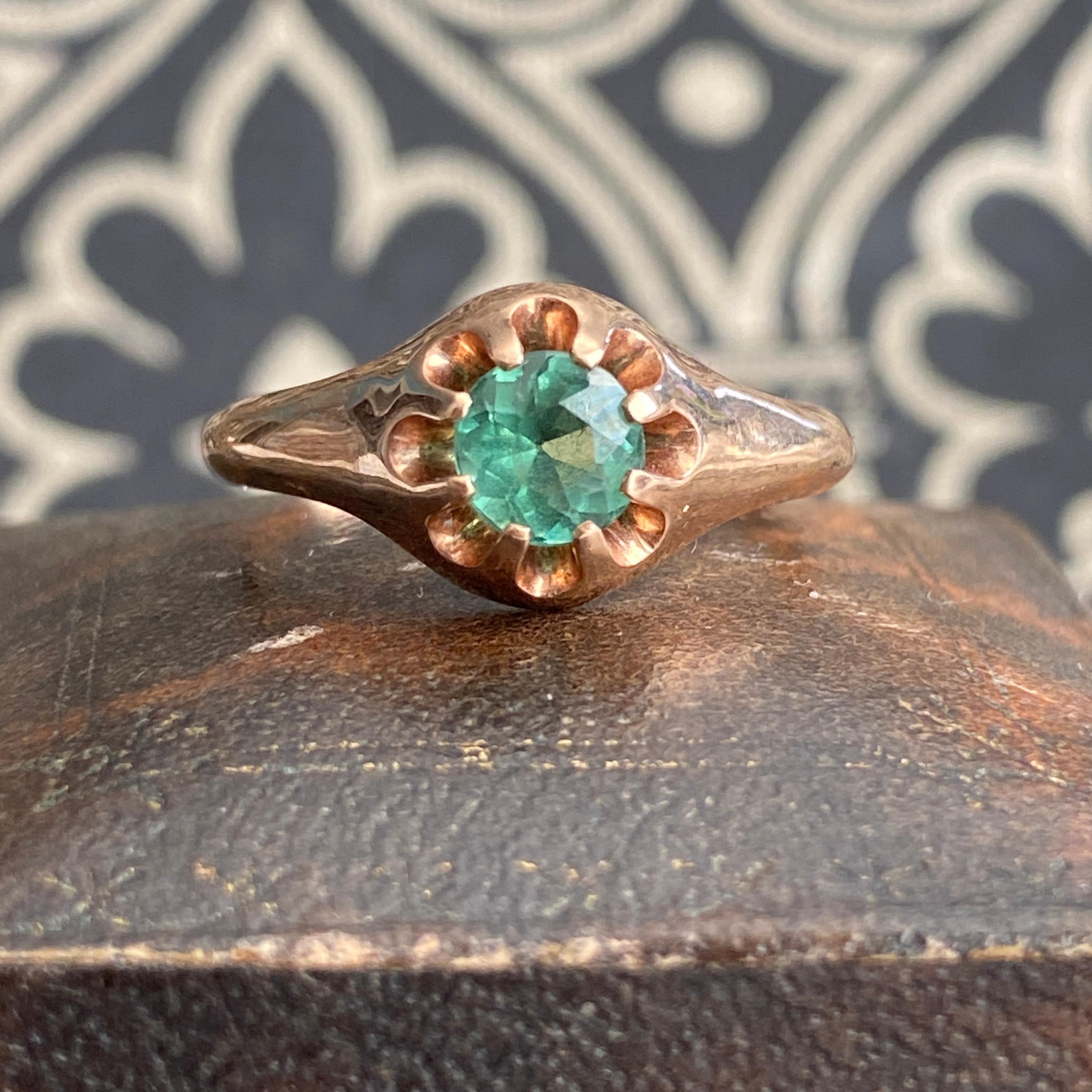 Details:
Very pretty vintage rose gold solitaire ring with a bright blue green tourmaline. Simple 14K rose gold with a raised prong set stone, this ring has a very classic sweet look! The green in the stone is green with a subtle blue cast—think of