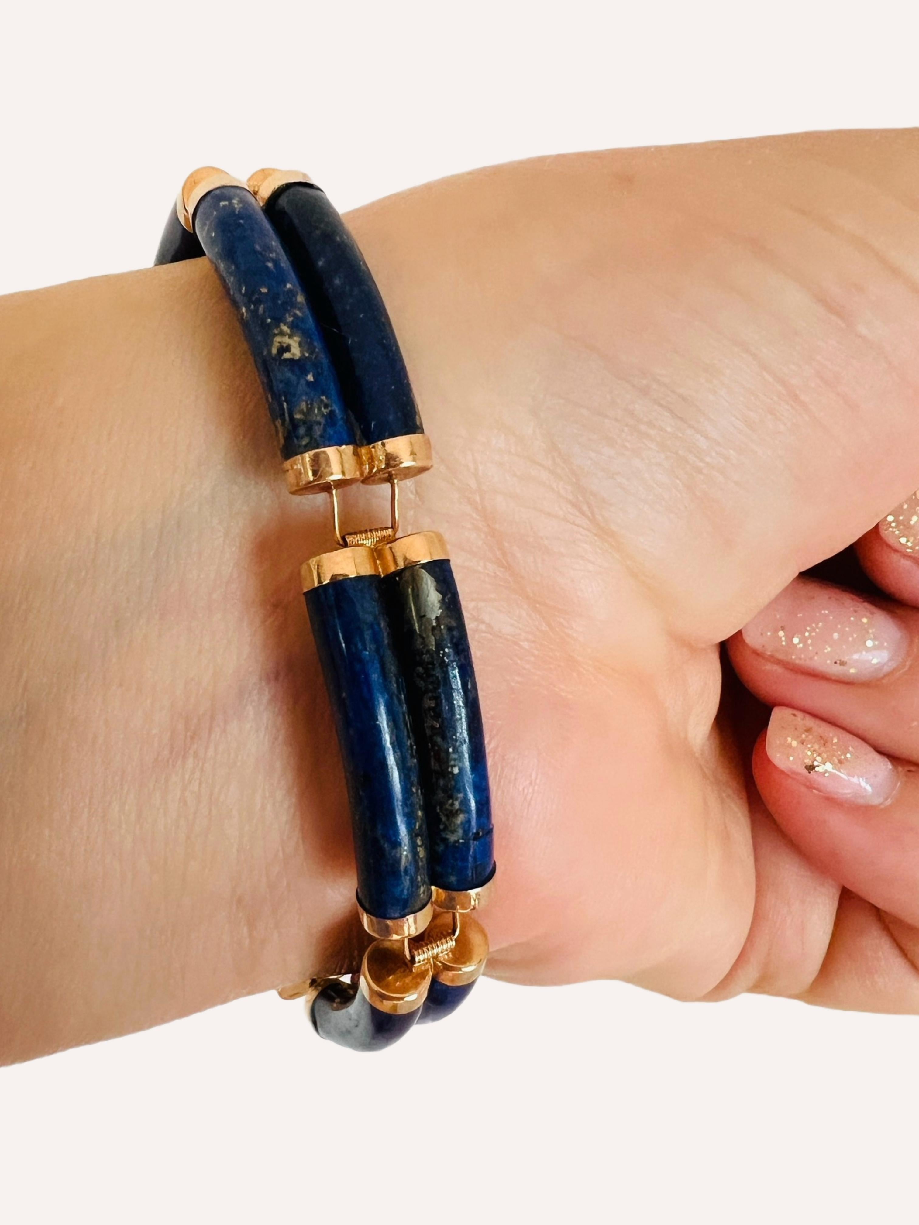 Elevate your style with a touch of good fortune. This bracelet features a box clasp adorned with the Chinese character for good luck, surrounded by double rows of rectangular lapis stations. The curved lapis stones are topped with 14kt yellow gold