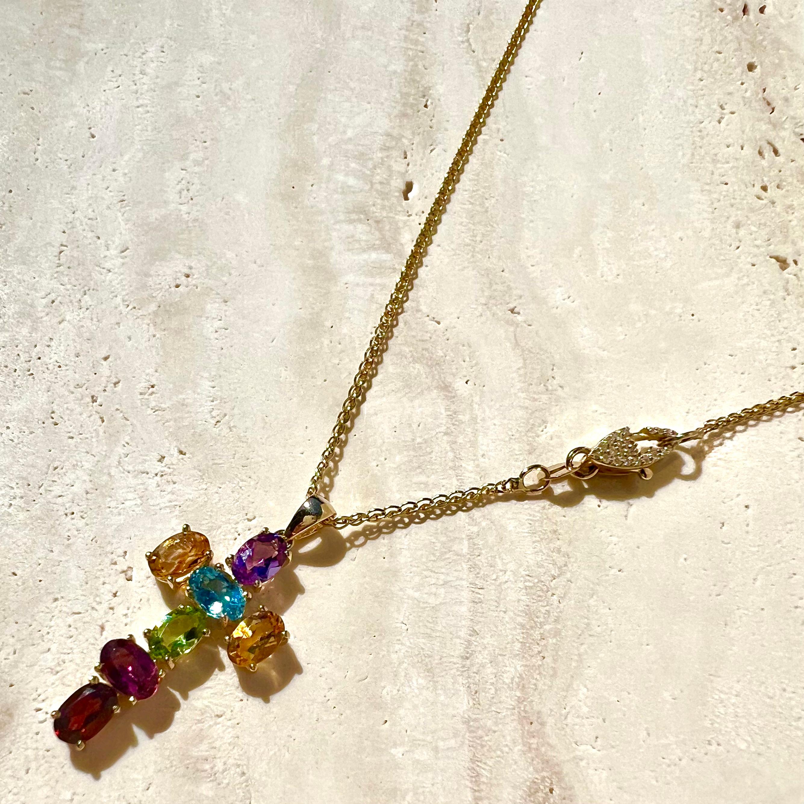 A 14k gold cross pendant composed of our dream stones...amethyst, citrine, blue topaz, peridot, rhodolite garnet, and garnet. Paired with a custom pavé double-sided diamond clasp and solid 14k gold wheat chain. Can be styled with the diamond clasp