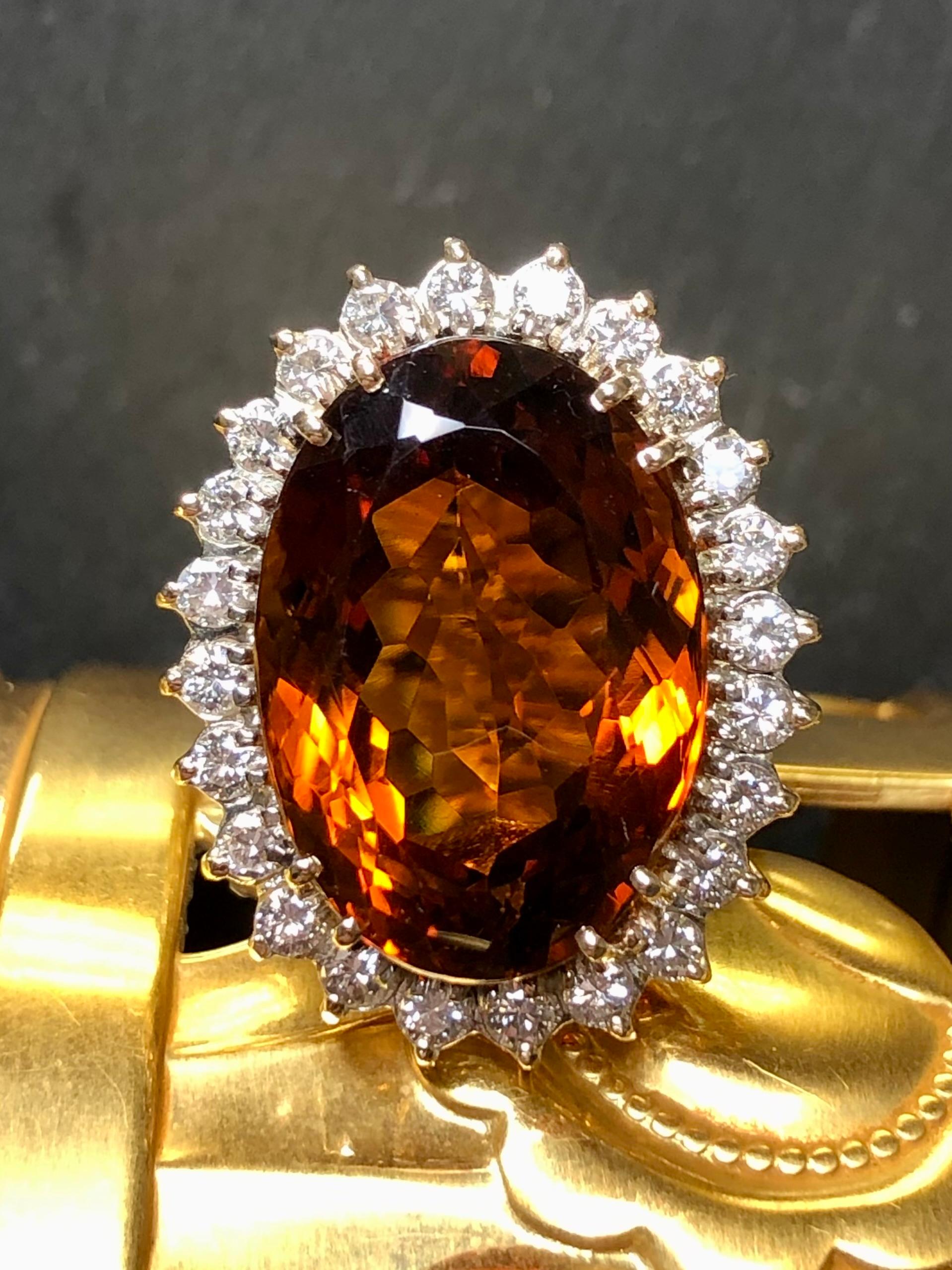
A stunning cocktail ring c. the 1960’s hand crafted in 14K yellow gold and centered by an absolutely gorgeous Madeira citrine with an approximate weight of 18.60ct. Surrounding the center is approximately 1.20cttw in G-H color Vs1-2 clarity round