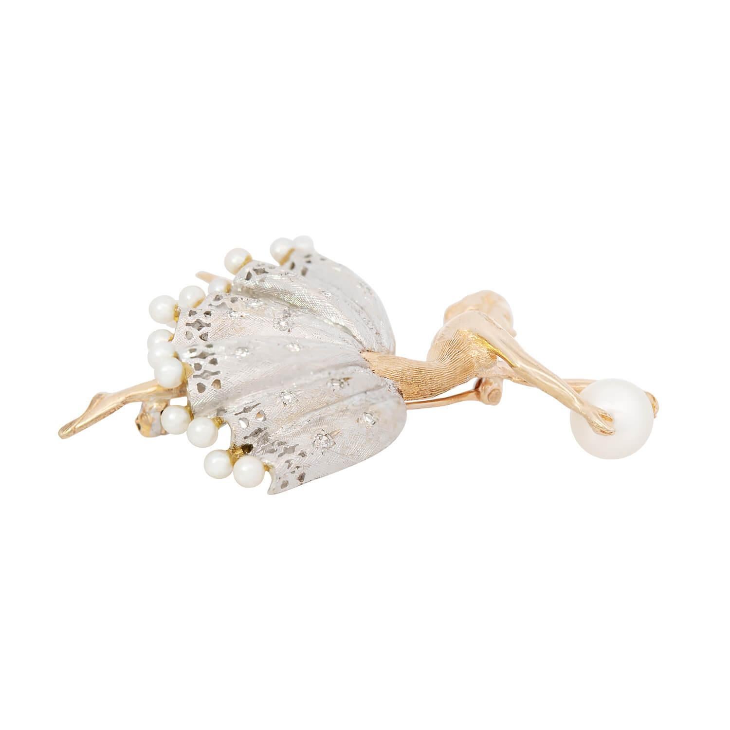 A stunning gold ballerina pin from the Vintage (ca1960s) era! This gorgeous 14k yellow and white gold pin portrays a graceful ballerina. The dancer's torso, head, arms, and legs are depicted in yellow gold. Her hair is held within a chic updo, as