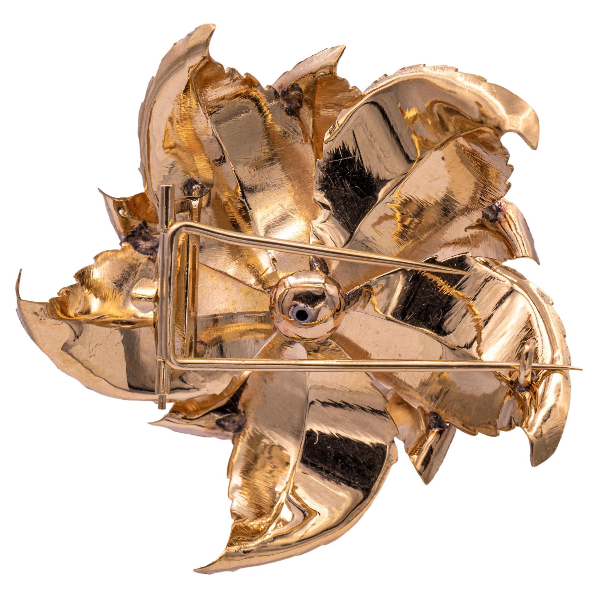 Vintage Flower brooch finely crafted in 14 karat rose gold with yellow gold details. Brooch has a silk satin textured finish with a diamond cluster center comprised of 7 single cut diamonds 0.42 carats total weight approximately. The brooch has a
