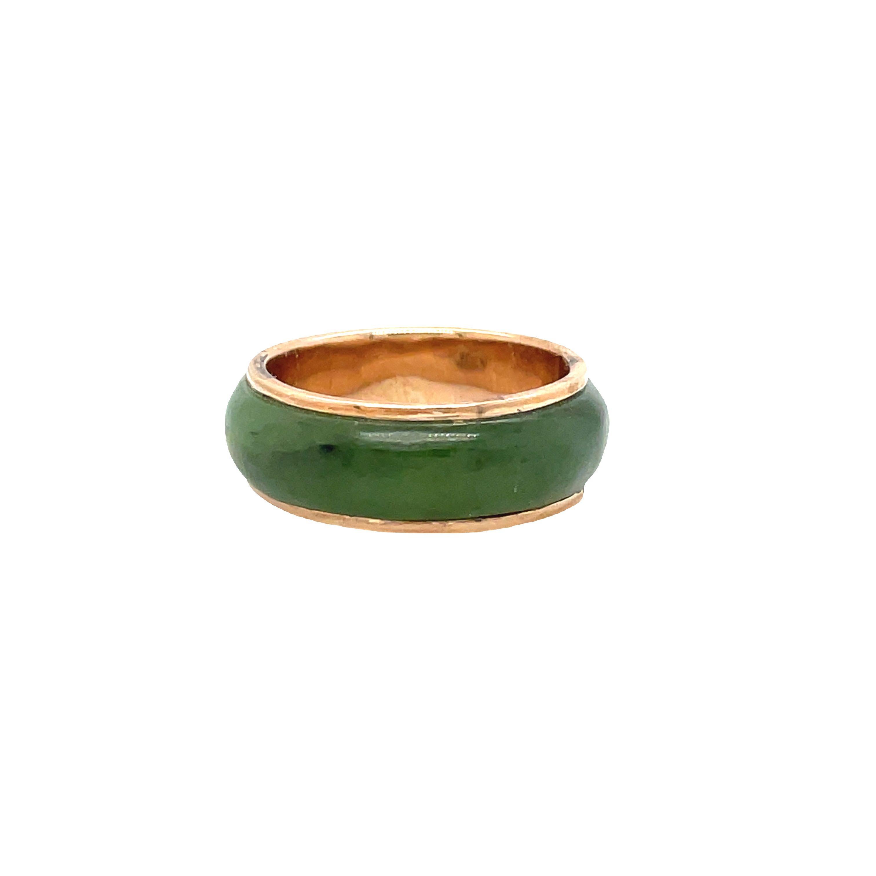 This beautiful ring is made of 14K rose gold and features natural jade gemstones that encircle the entire band. The jade stones are perfectly carved and create a symmetrical design that adds elegance to the ring. The edges of the ring are