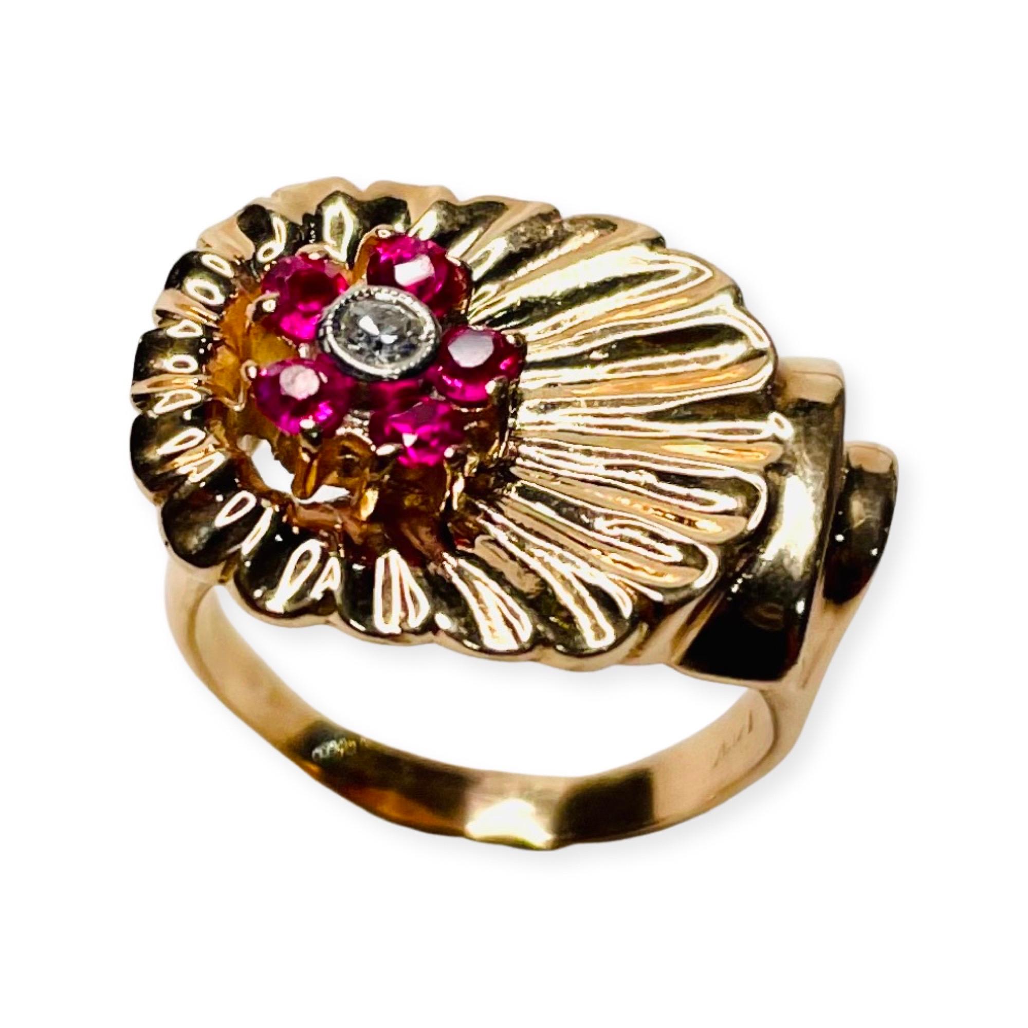 Lithos 14K Rose Gold Single Cut Diamonds and Synthetic Ruby Period RIng. There is one, 0.10 carat diamond of SI Clarity and H Color. It is bezel set. There are 5 rubies, channel and 2 prong set, around the center diamond. It is finger size 6.5 but