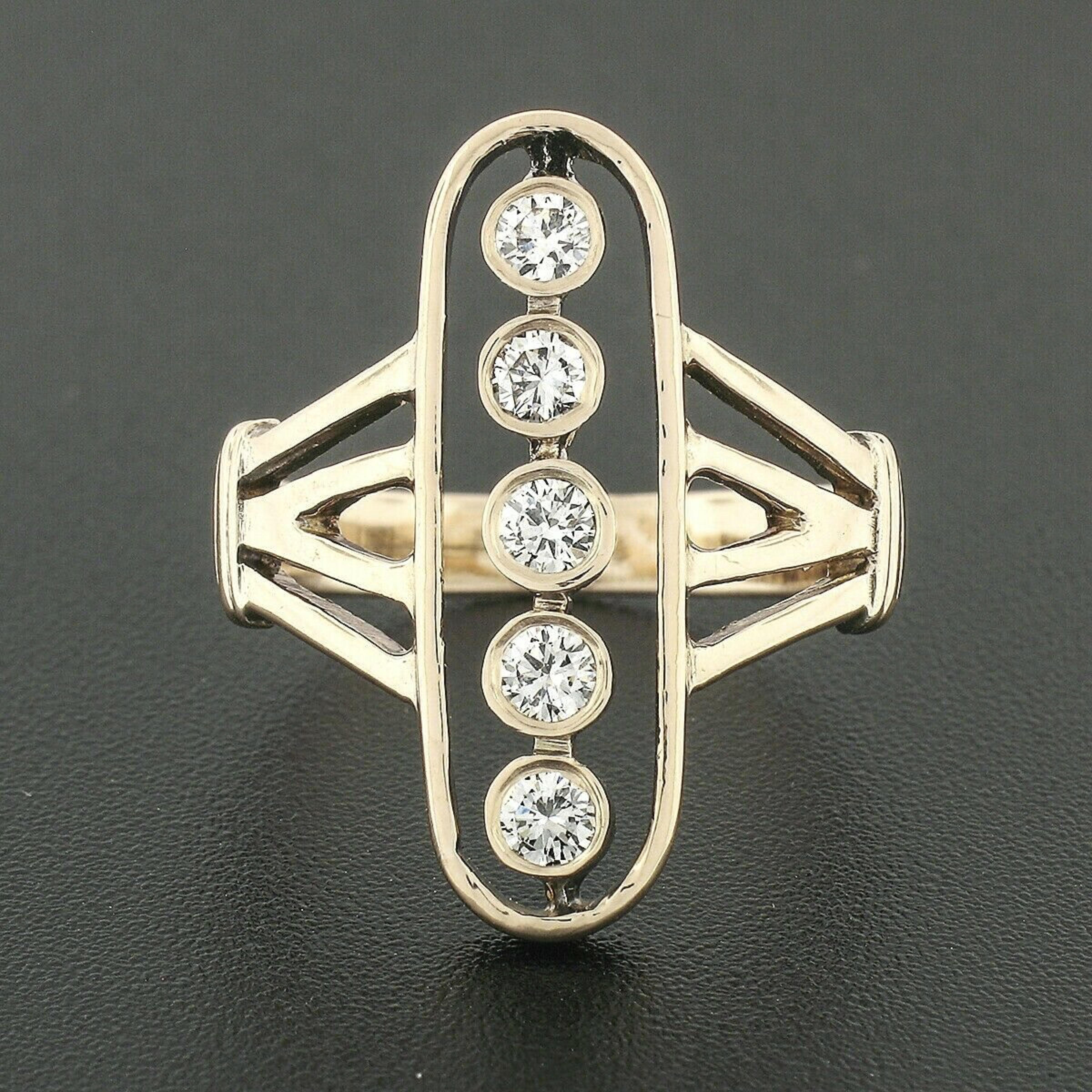 This unique elongated oval diamond ring is crafted in solid 14k rosy yellow gold. This beautiful vintage ring from the 1940's features five old traditional cut diamonds that are bezel set and have a near colorless F/G color with VS1/VS2 clarity. The