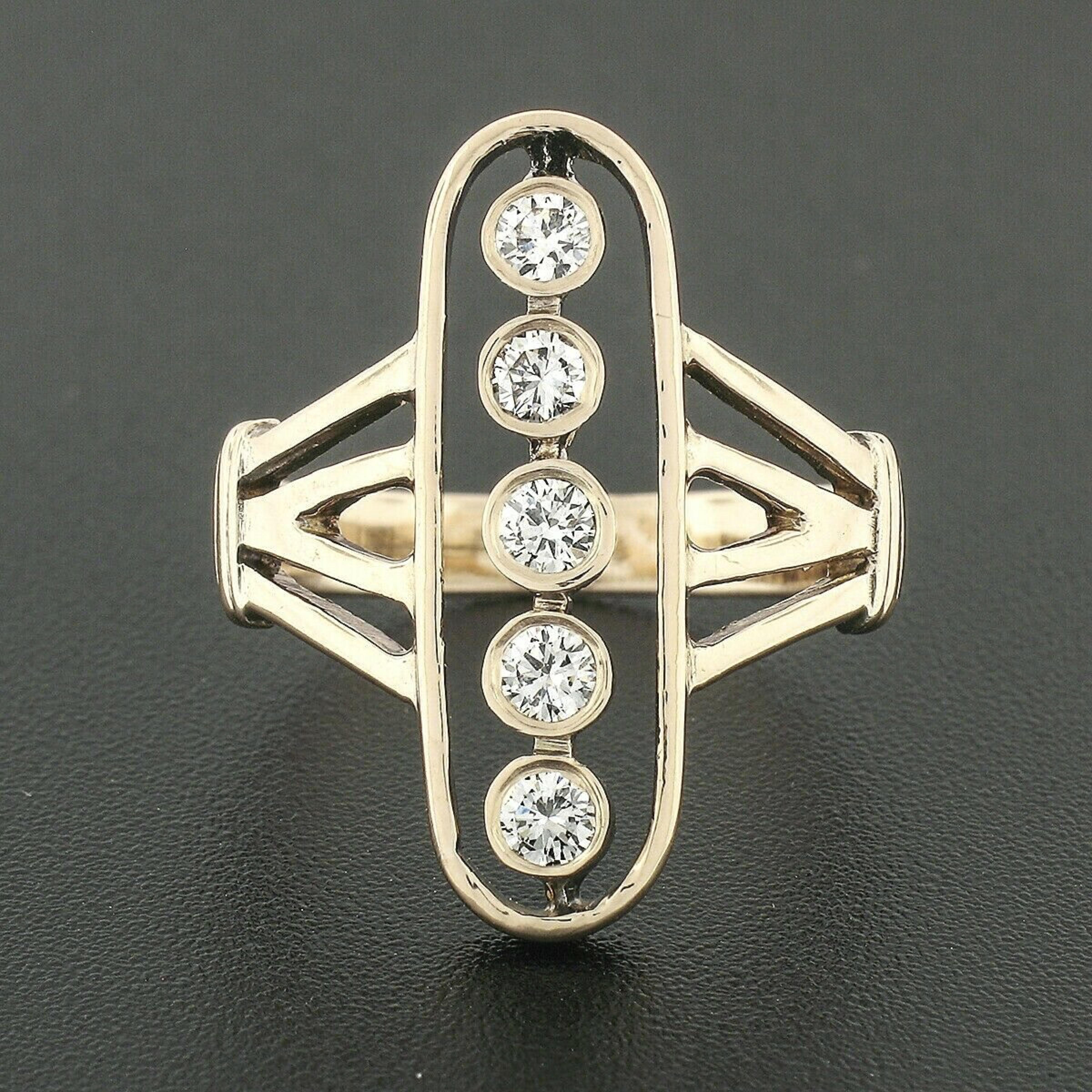 This unique elongated oval diamond ring is crafted in solid 14k rosy yellow gold. This beautiful vintage ring from the 1940's features five old traditional cut diamonds that are bezel set and have a near colorless F/G color with VS1/VS2 clarity. The