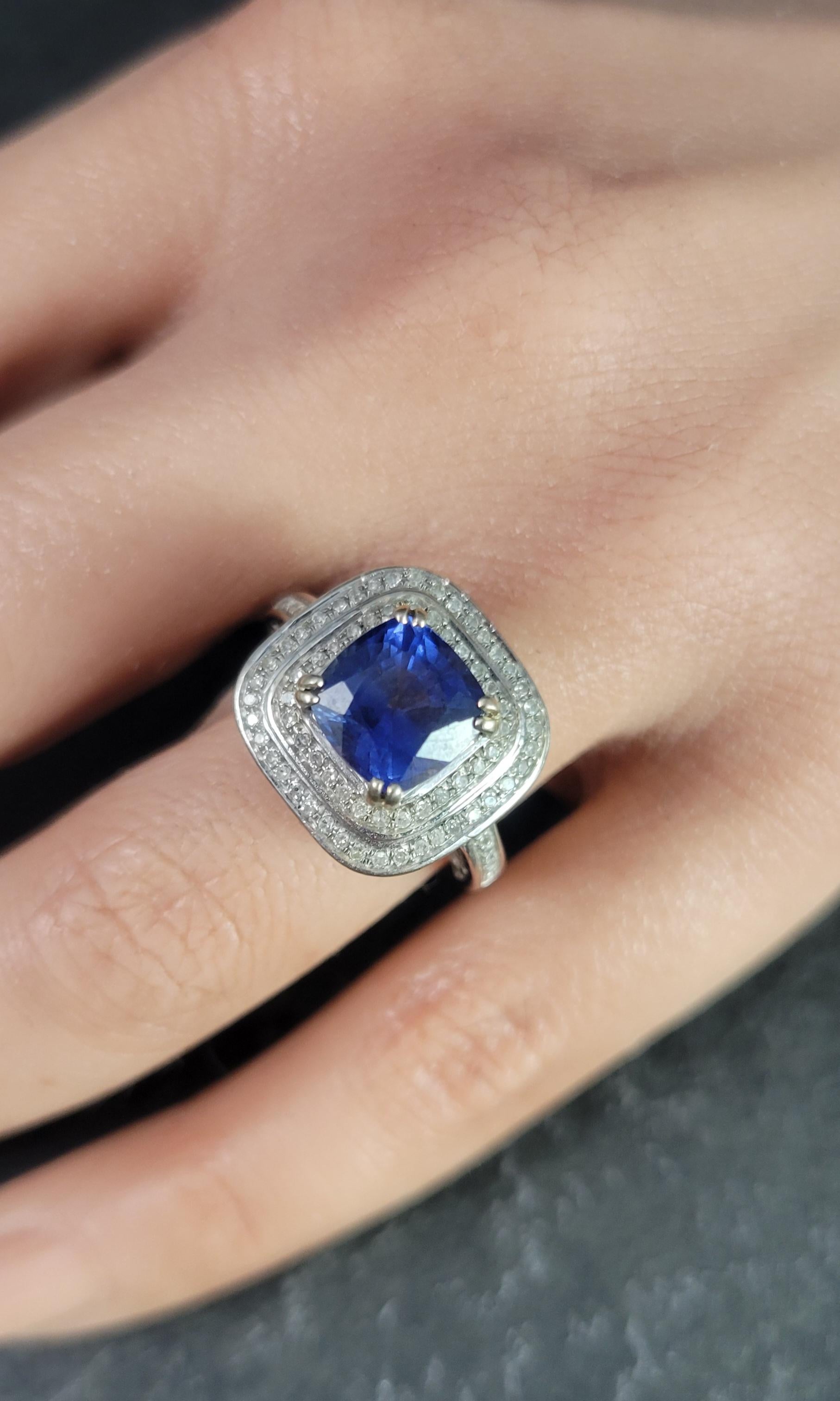 This high set sapphire and diamond ring is not only pleasing to the eye, it's also comfortable.

The gorgeous cushion cut sapphire is a 3 carat, vibrant blue with hints of purple. It measures 8x8 mm.
It is accented by apx 1 total carat weight of