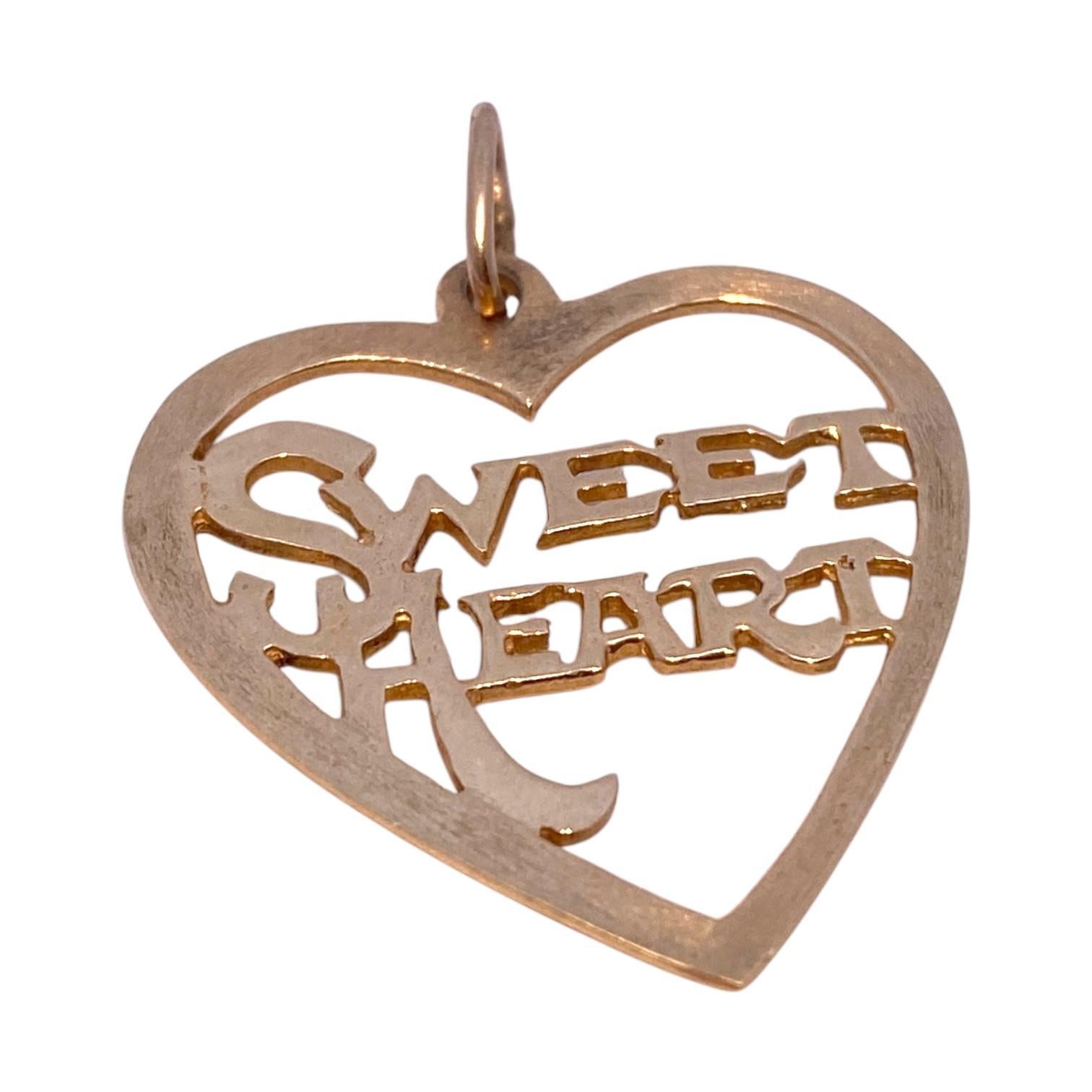 Crafted in 14K yellow gold, this charm features an openwork heart design with the word 