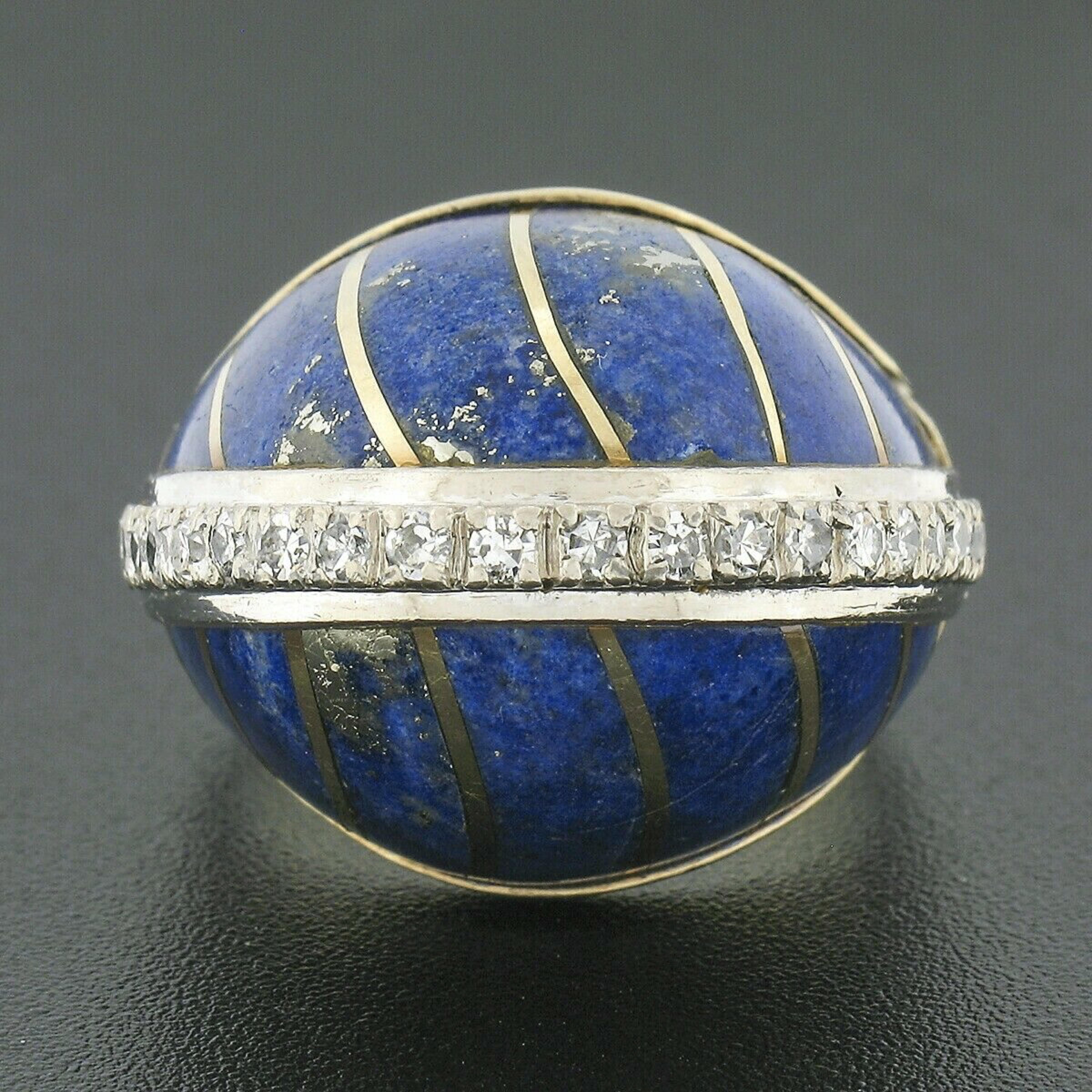 This magnificent, vintage, bombé style ring was crafted from solid 14k yellow gold. It features a large domed top with an elegant design that is constructed from inlaid set lapis stones and inlaid yellow gold stripes. The fine lapis are well matched