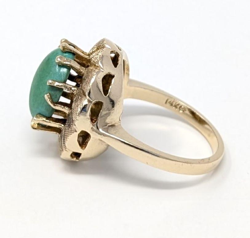 Elegant vintage 14k solid yellow gold ring featuring a light green turquoise cabochon centerpiece. This statement ring best fits for a size 7 finger and measures .65 inch in width by .7 inch in length. Stamped 14k on the interior of the band, please