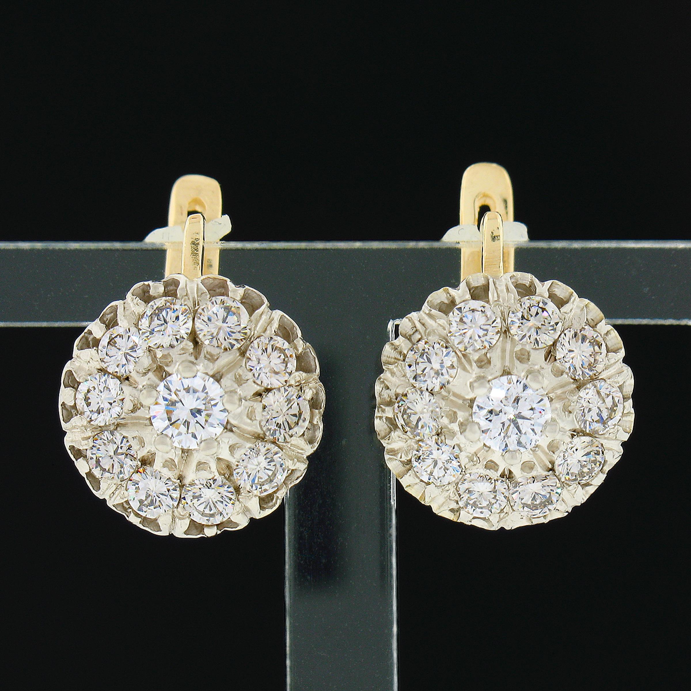 These fancy vintage earrings were crafted from solid 14k yellow and white gold and feature an elegant drop style set with a stunning and super lively diamond cluster at their bottom. These round brilliant cut diamonds total approximately 1.65