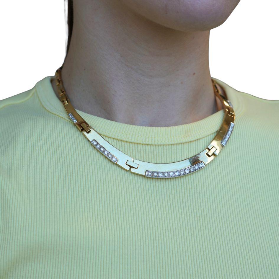 This vintage necklace, crafted in the late 1980s to early 1990s, embodies the bold and refined aesthetic of the era. Made in 14k two-tone gold, the necklace features alternating polished yellow gold links accented with white gold diamond panels,