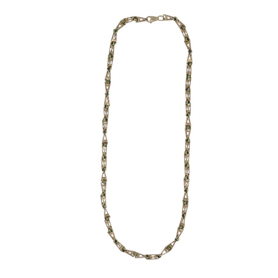 This vintage 14k two-tone gold Soviet geometric chain link necklace, circa 1920s, is a unique design featuring a mix of rose gold and yellow gold. Weighing 37.5 grams and measuring 21.75 inches in length, the necklace showcases 3D triangular rose