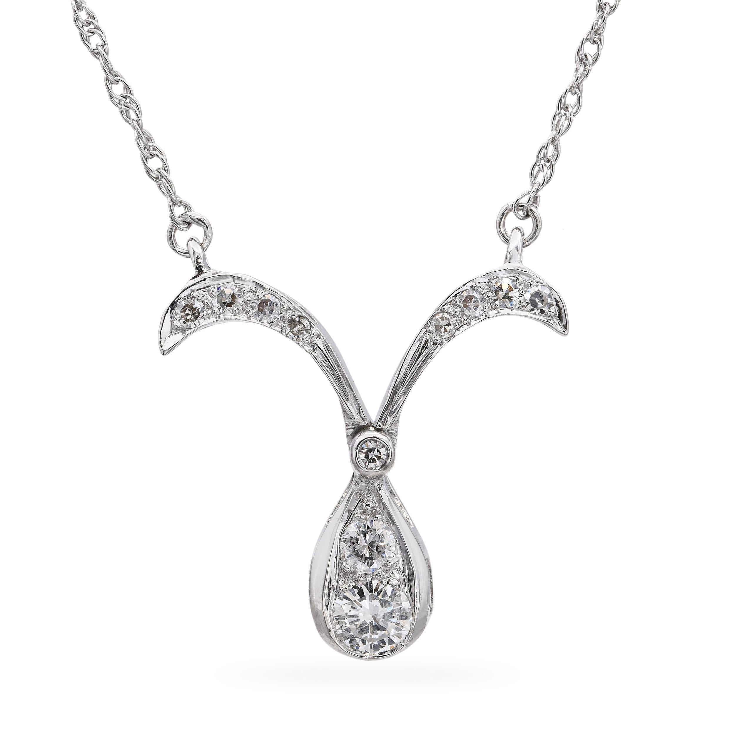 This elegant vintage pendant is crafted in 14k white gold and showcases a sleek, modular design with clean geometric lines and contemporary flair. The drop-style silhouette is accented with brilliant-cut diamonds, adding refined sparkle and visual