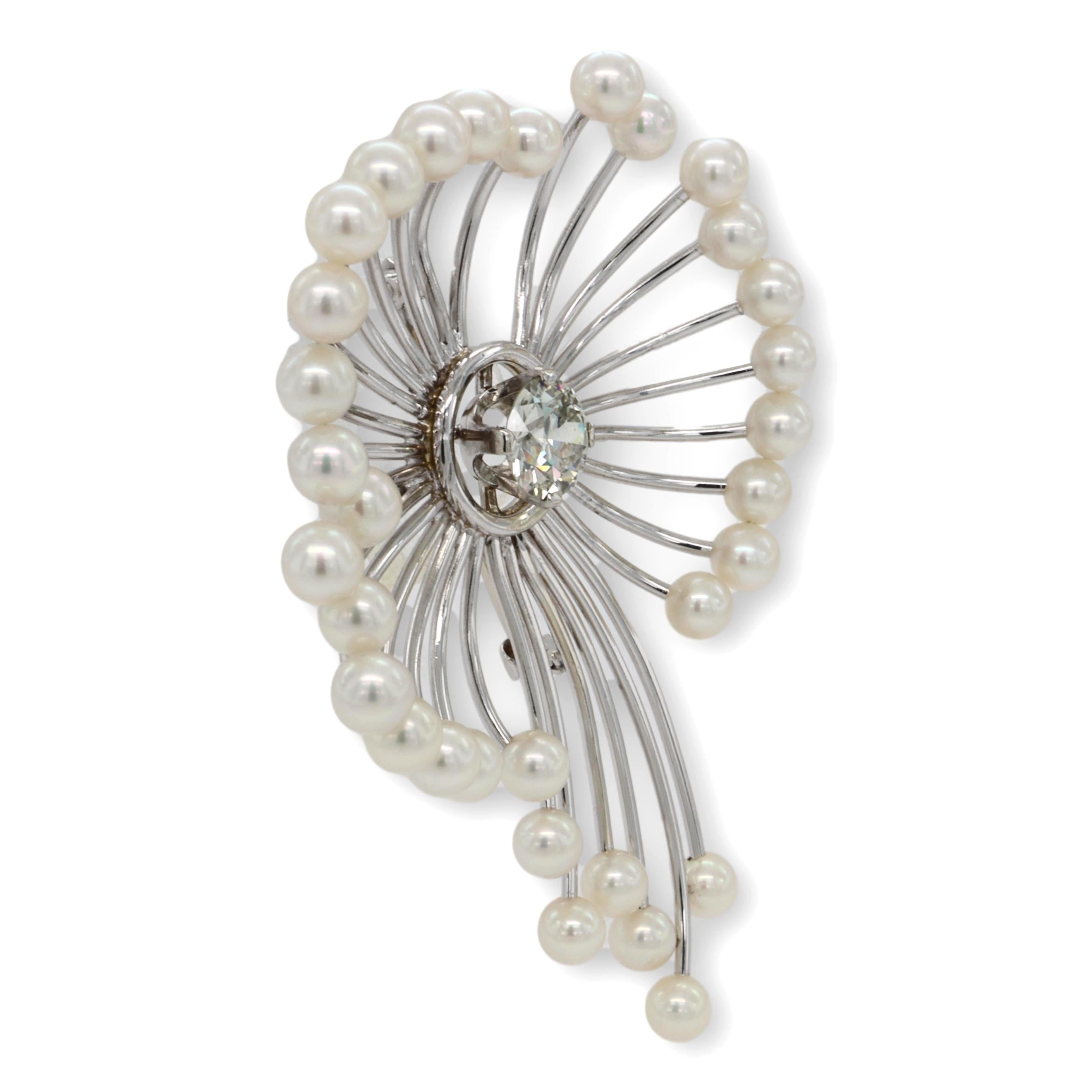 Vintage brooch finely crafted in 14 Karat white gold featuring an old-european cut diamond center weighing 1.25 carats, eye- clean diamond adorned with 32 Akoya 4.0-4.3 mm seed pearls in an open flower shape design. Pin closure with C clasp and