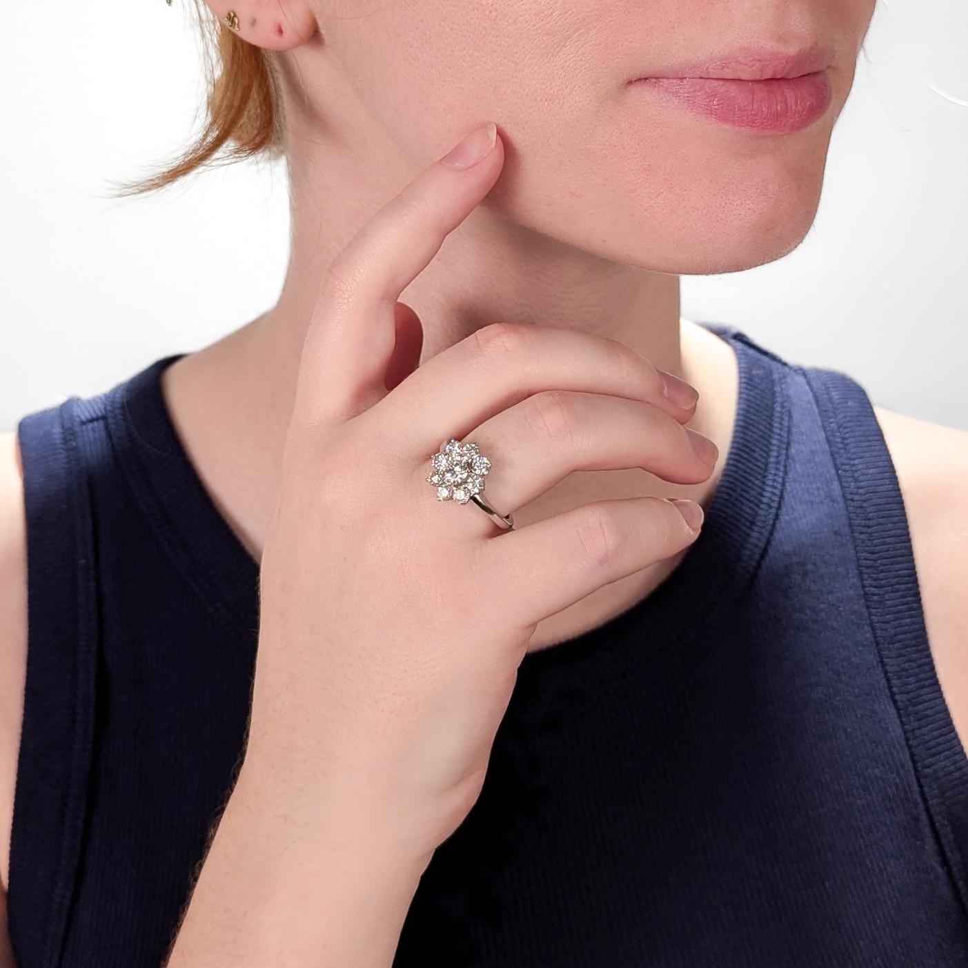 A very fine white gold & natural diamond cocktail ring.

In 14 karat white gold.

Comprised of a central round brilliant cut 0.85± ct. diamond (Color G-H, Clarity VVS-VS) surrounded by a halo 8 round brilliant cut diamonds (ca. 1.40± Ctw; Color: