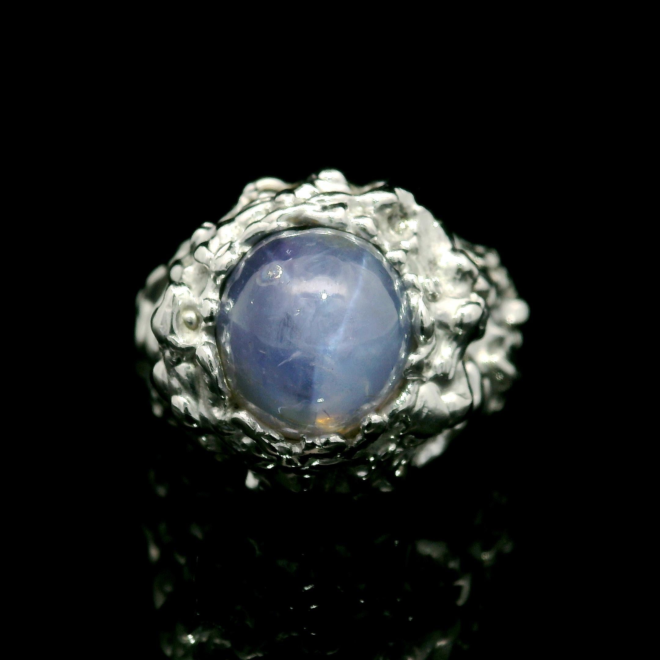 –Stone(s)–
(1) Natural Genuine Star Sapphire - Oval Cabochon - Prong Set - Light to Medium Blue Color  - Very Nice Star - 7ctw (approx.) - 9x8.61mm (approx.)
Material: Solid 14k White Gold
Weight: 14.26 Grams
Ring Size: 6.5 ( fitted on finger, item
