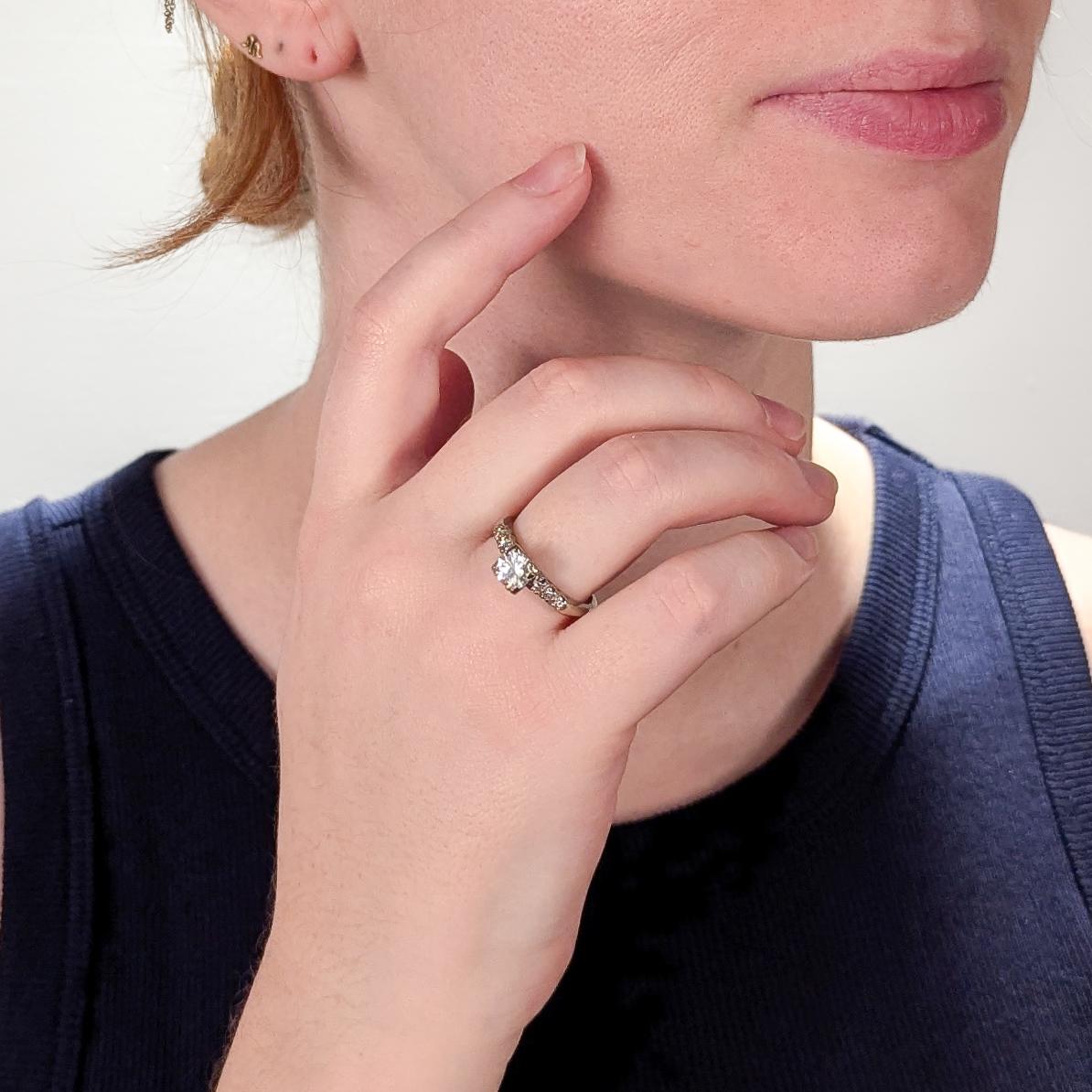 A fine vintage white gold & diamond engagement ring.

In 14 karat white gold.

With a central prong-set round brilliant cut 0.90± Ct natural diamond flanked on both sides by 3 single cut diamonds.

Marked to the shank.

Accompanied by a GEMLAB