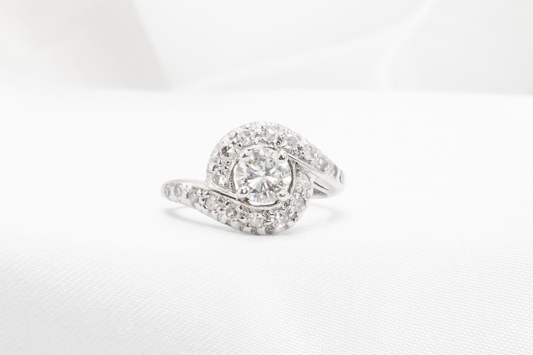 Vintage 14K White Gold Bypass Diamond Ring

A timeless design with vintage charm, this 14K white gold bypass ring showcases a sparkling round brilliant center diamond, approximately 0.58 carats, with K color and SI clarity. Accented by additional