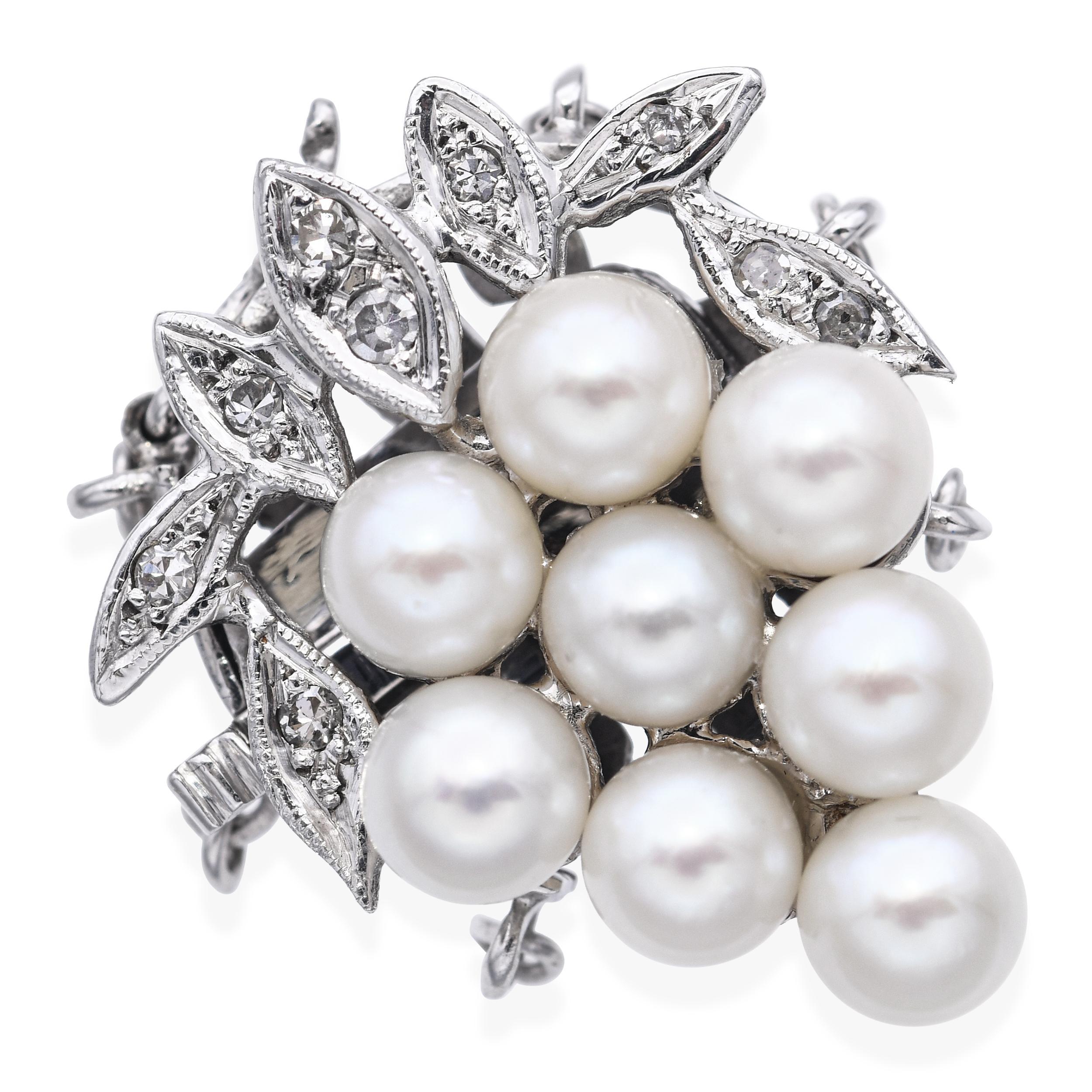 This exquisite vintage clasp is crafted in 14k white gold and designed in the shape of a grape cluster, adorned with lustrous pearls and twinkling diamond accents. The intricate detailing captures the natural elegance of the motif, making it a