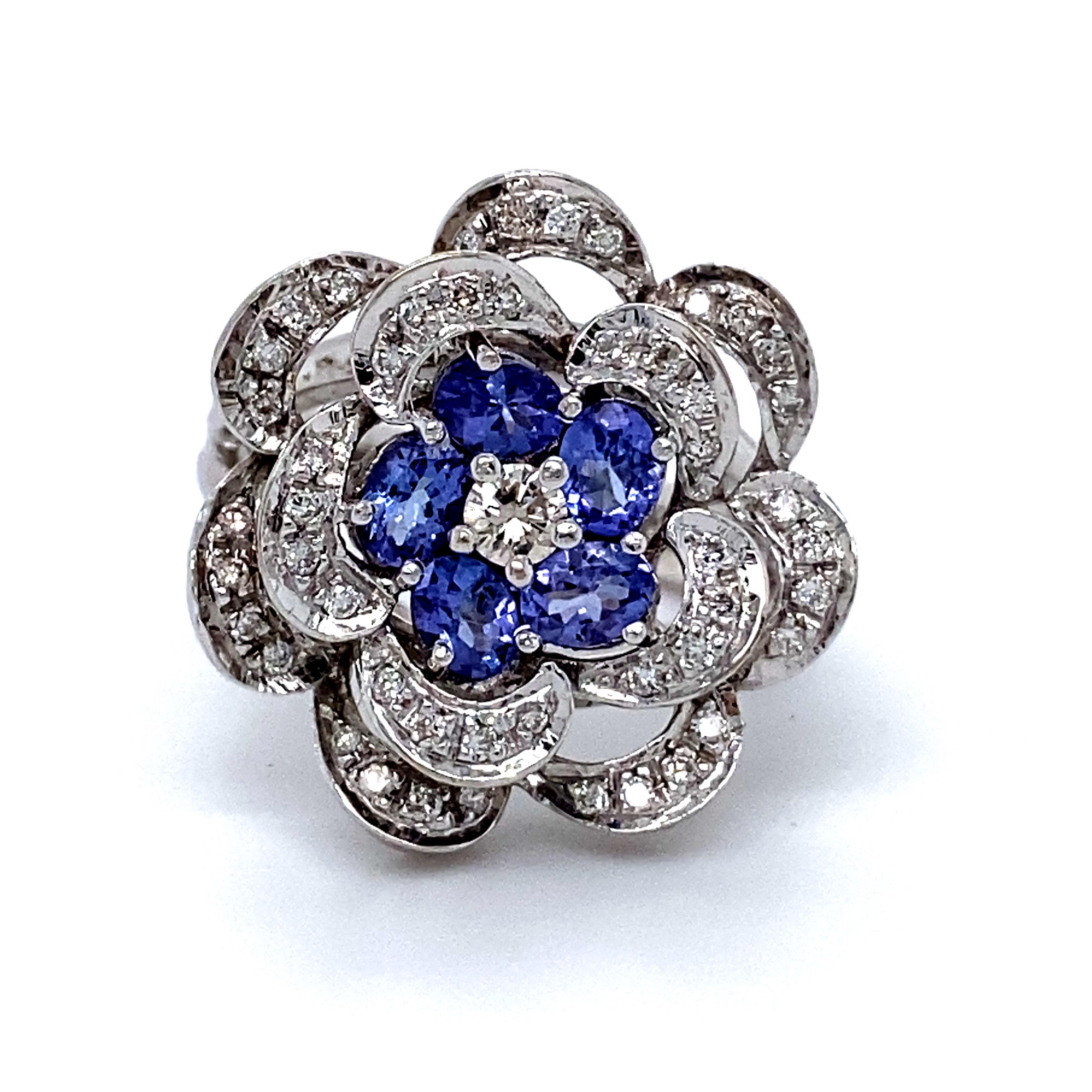 This Beautiful Vintage Diamond and Tanzanite Cluster Ring by Le Vian is so stunning and sparkly I'm temped to keep it for myself. Crafted in 14K White Gold, the design is a beautiful floral cluster, with a diamond center, tanzanite surrounding, and